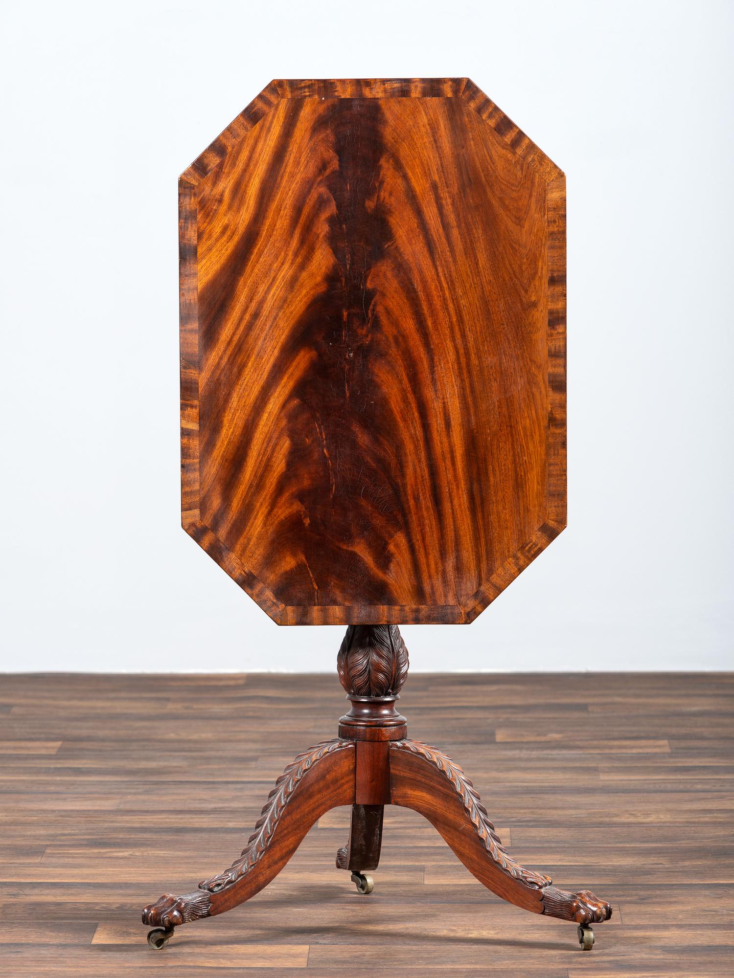 A Late Federal Carved and Figured Mahogany Octagonal Tilt-Top Candlestand
