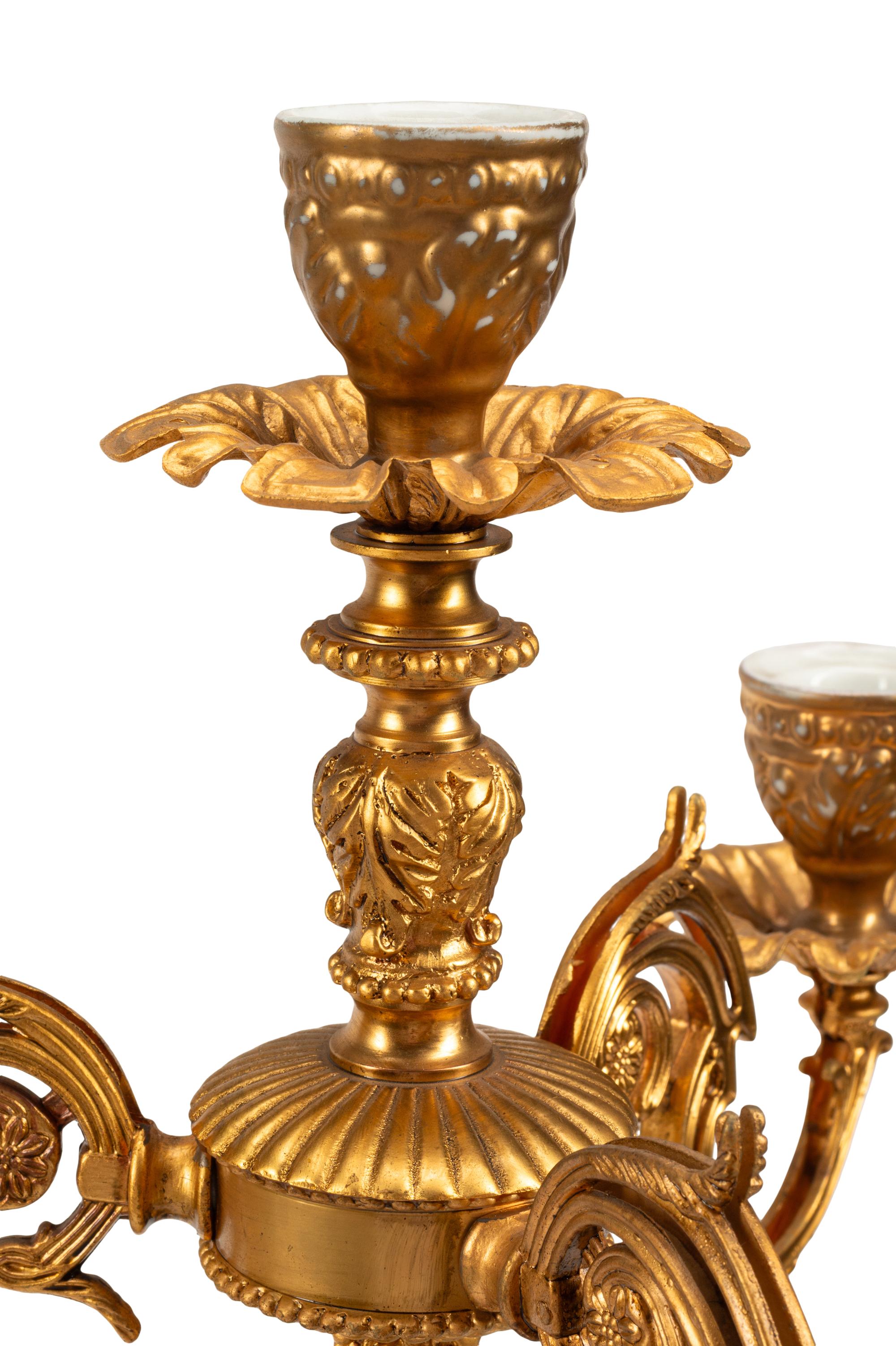 A Pair of Gilt Metal and Porcelain Figural Four-Light Candelabra