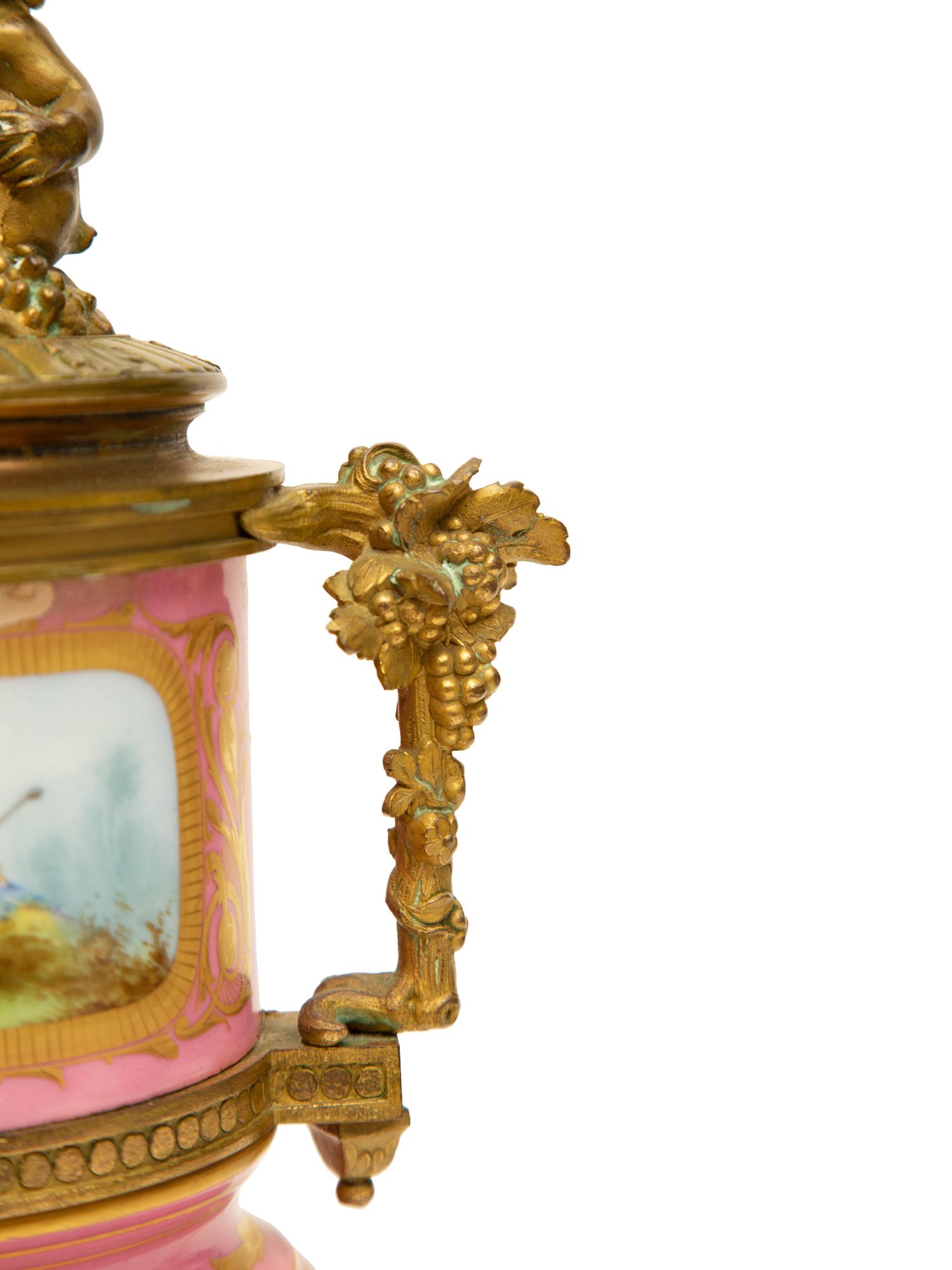 A Pair of Gilt Bronze Mounted Sèvres Style Porcelain Urns Mounted as Lamps