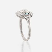 A diamond, emerald, and platinum ring