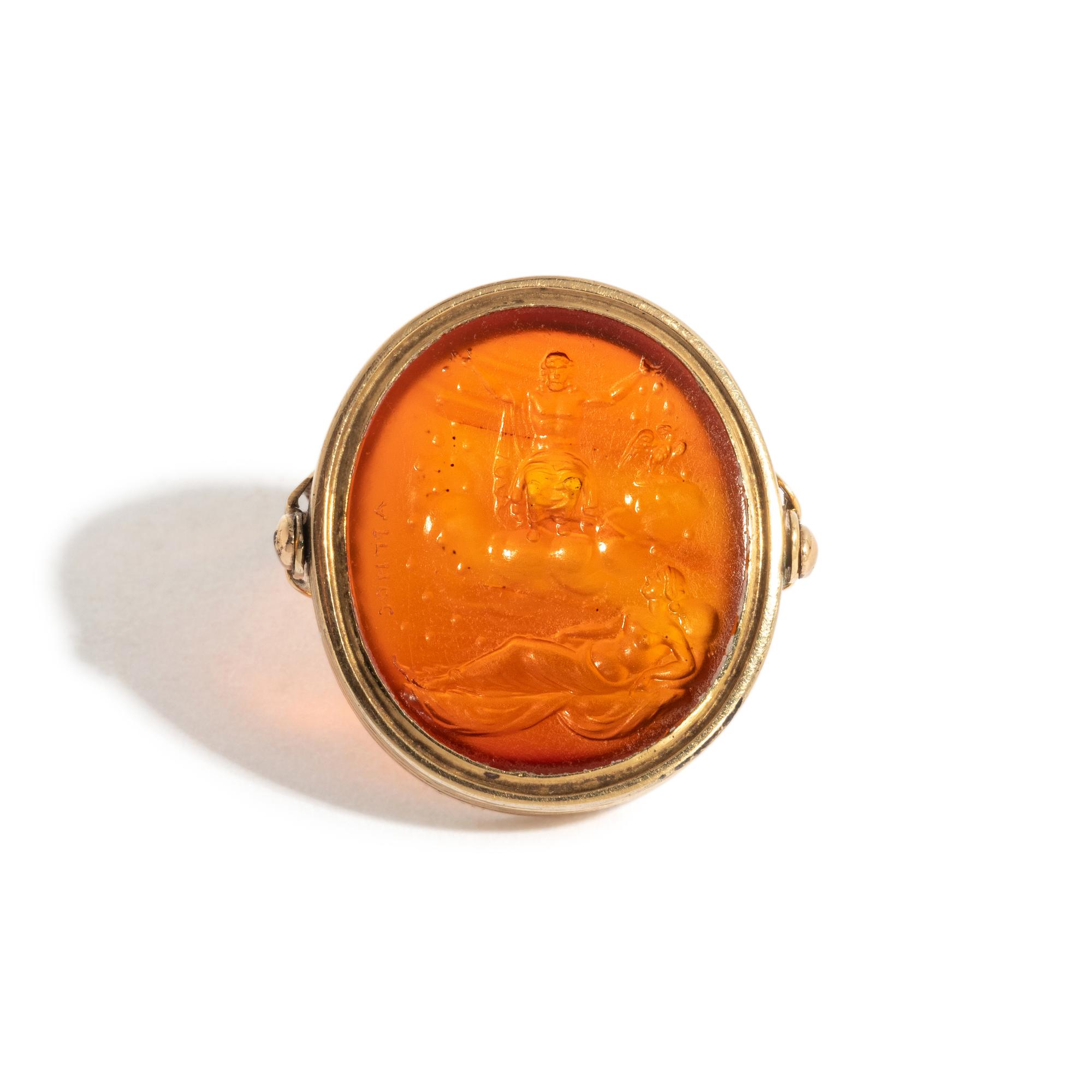 A Neoclassical Gold and Carnelian Finger Ring with the God Zeus, a Reclining Female, and a Greek Inscription