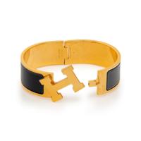 A Group of Three Costume Jewelry Pieces by Hermès and Chanel