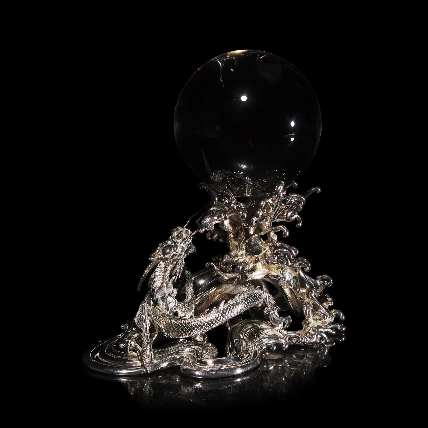 A Japanese Rock Crystal Sphere and Silver 'Dragon and Waves' Stand, Signed Yoshimasa Saku Meiji/Taisho Period 日本明治/大正時期 義正作潮を支配する珠と龍