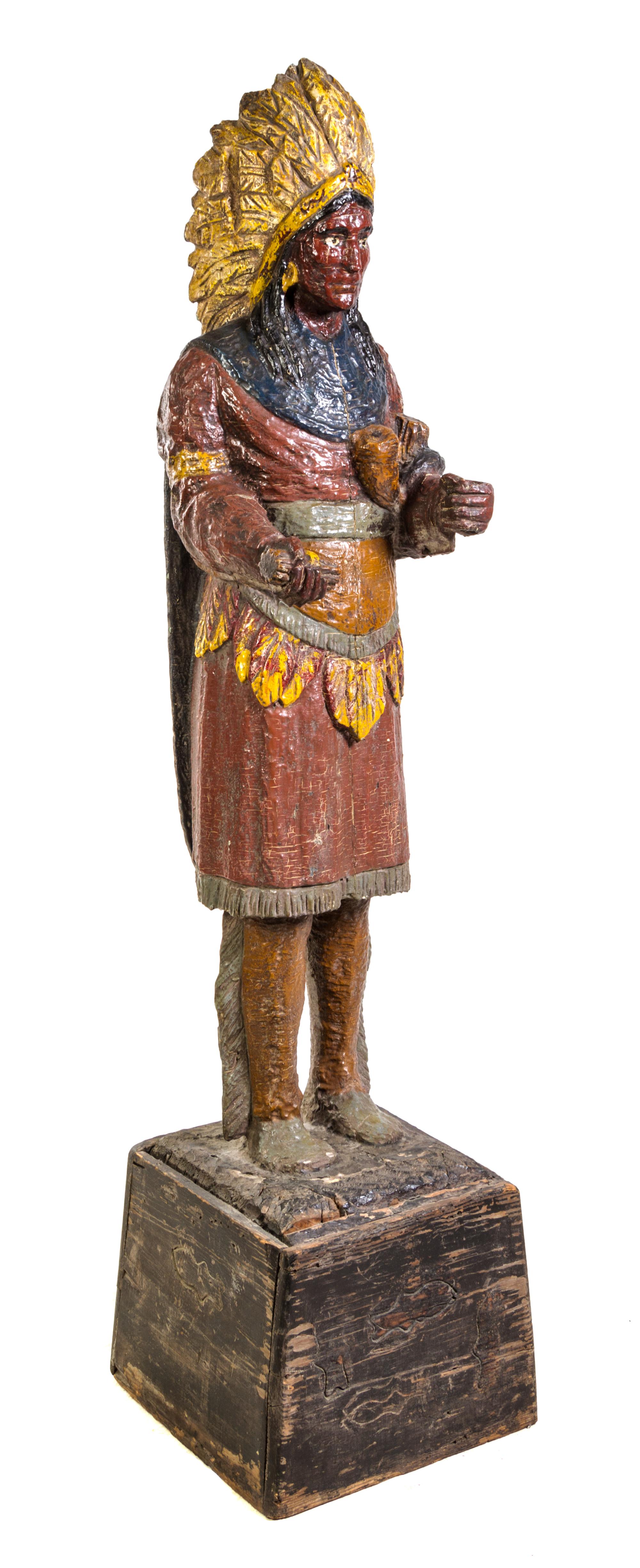 A Carved and Polychrome Painted Cigar Store Indian Height overall 71 inches. — EARLY 20TH CENTURY