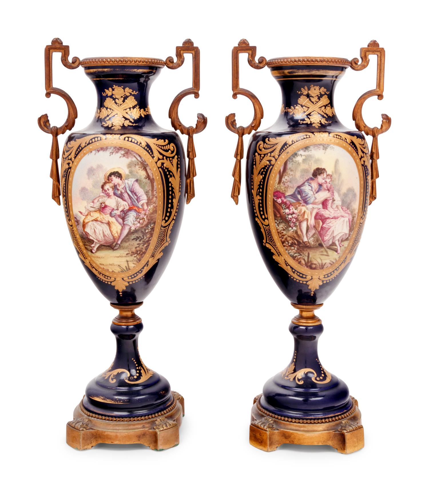 A Pair of Sèvres Style Gilt Bronze Mounted Porcelain Urns
