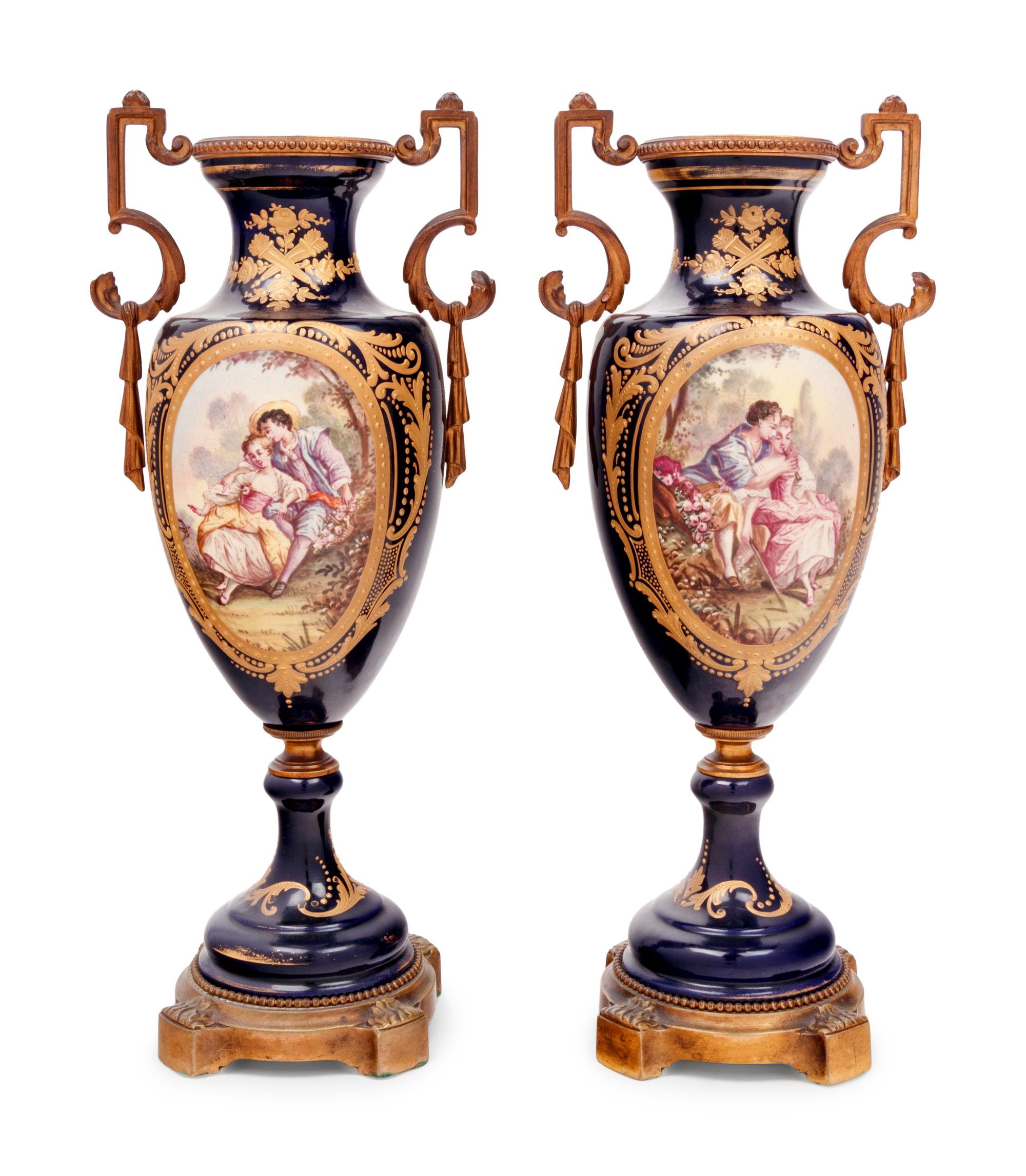 A Pair of Sèvres Style Gilt Bronze Mounted Porcelain Urns
