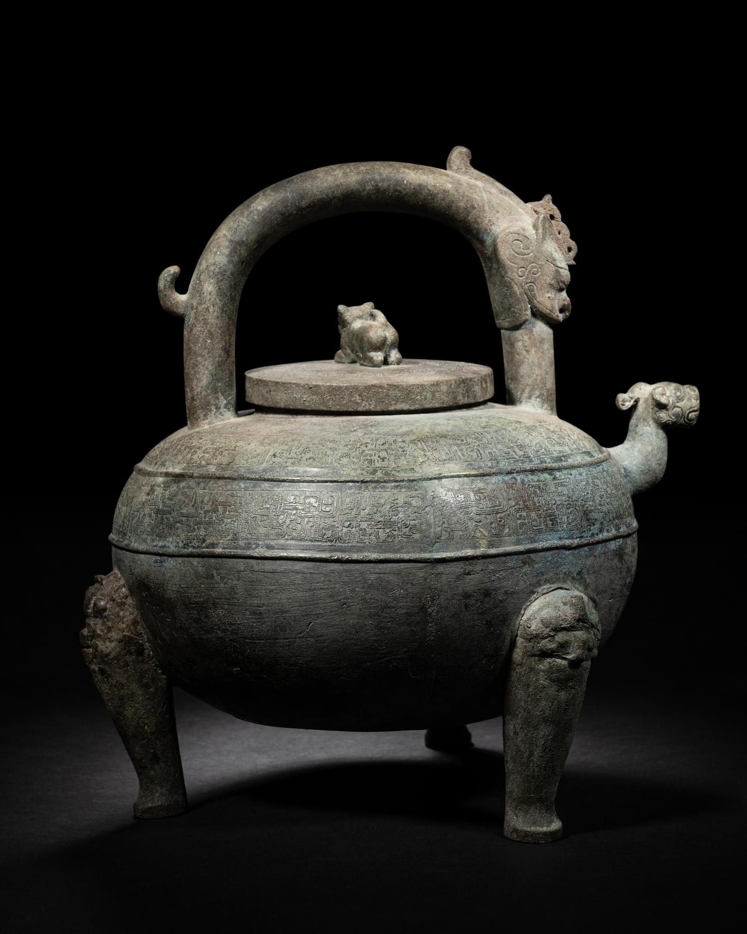 An Archaic Bronze Tripod Wine Vessel, He
