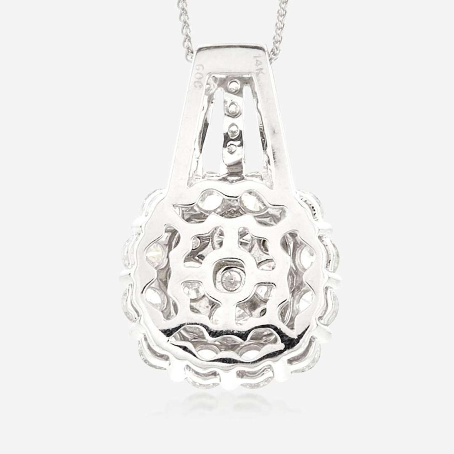 A diamond and fourteen karat white gold pendant