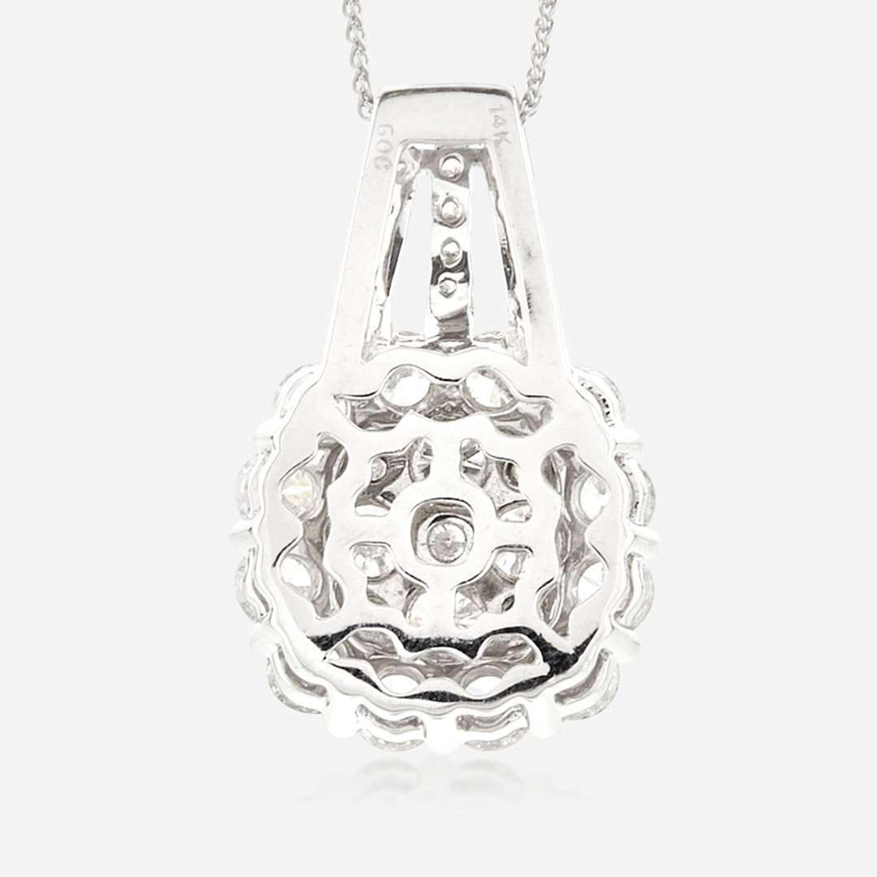 A diamond and fourteen karat white gold pendant