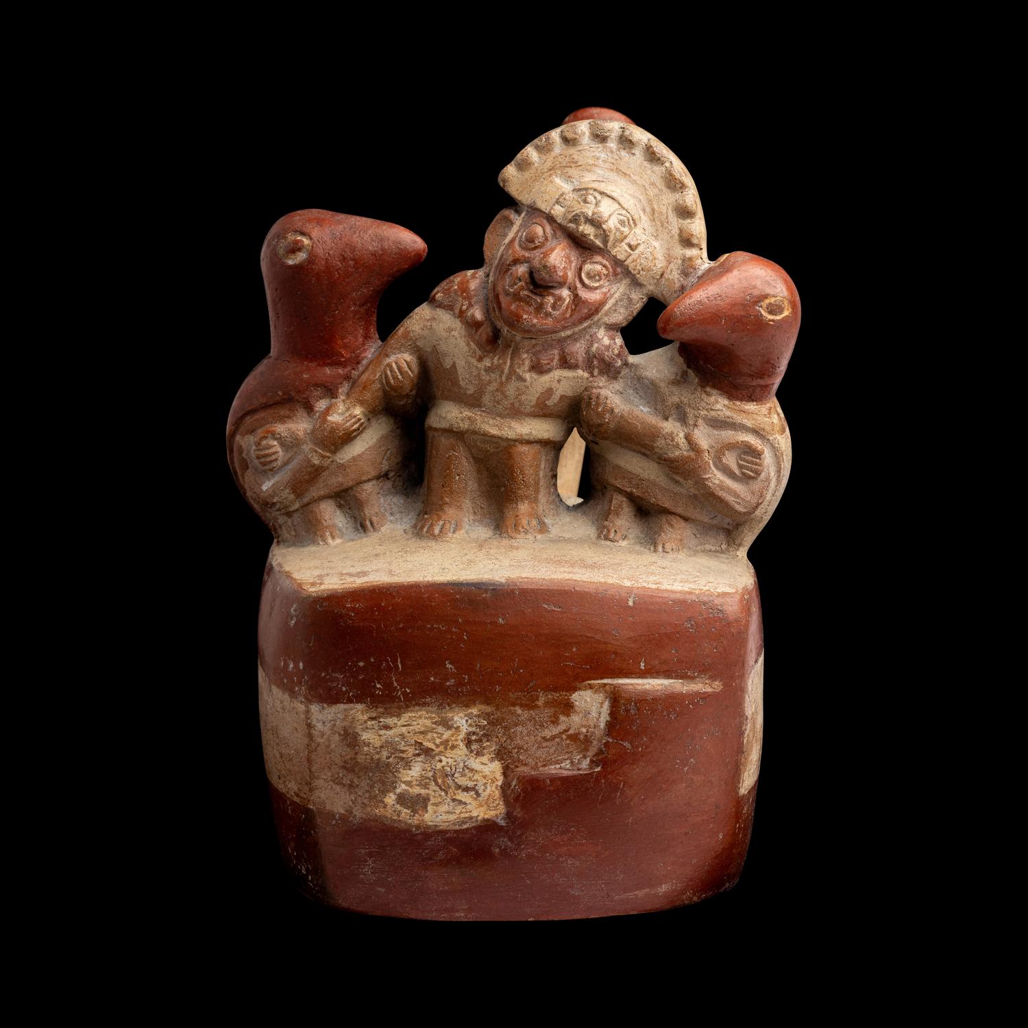 A Moche Stirrup Vessel in the Form of a Shaman with Two Anthropomorphic Figures