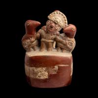 A Moche Stirrup Vessel in the Form of a Shaman with Two Anthropomorphic Figures