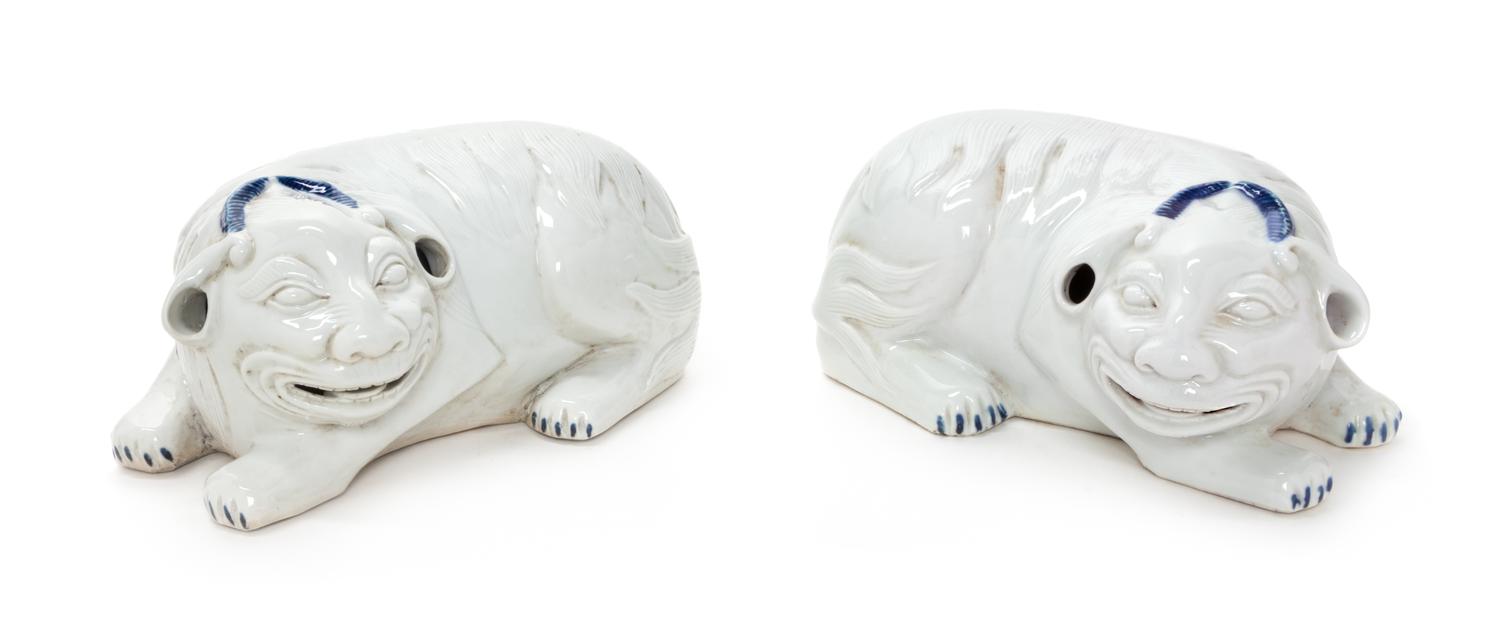 A Pair of Chinese White Glazed Porcelain Mythical Beasts Length of each 10 1/2 inches. — 20TH CENTURY