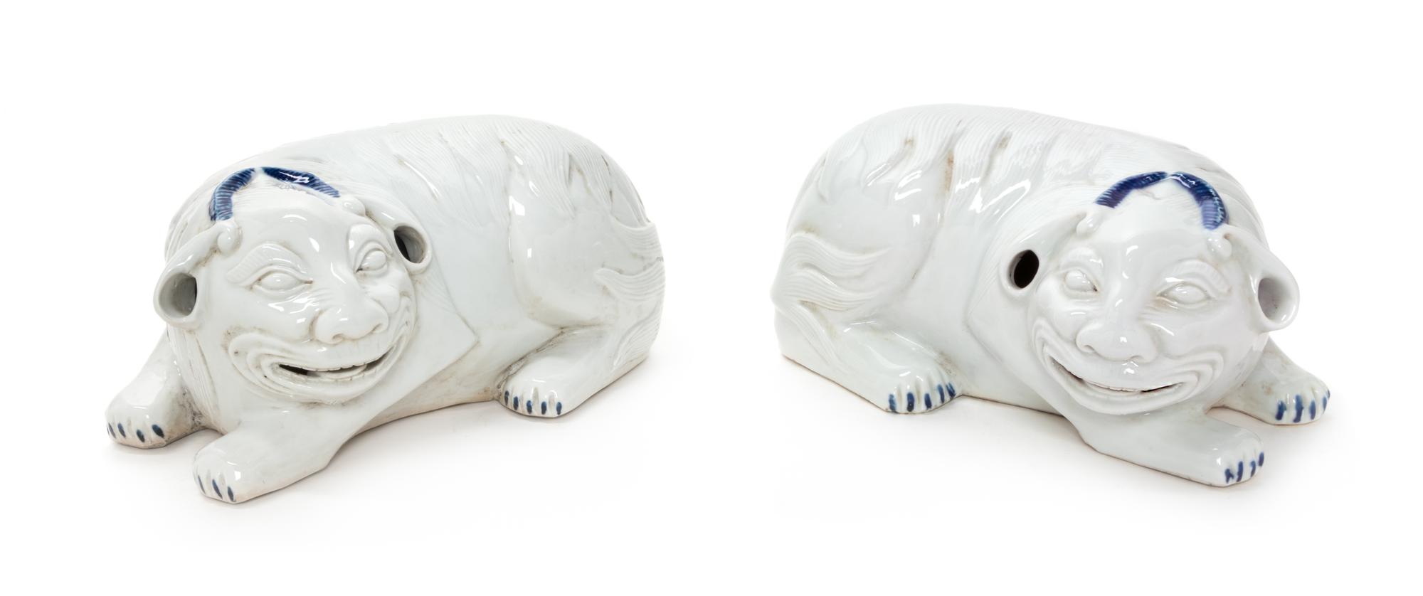A Pair of Chinese White Glazed Porcelain Mythical Beasts Length of each 10 1/2 inches. — 20TH CENTURY