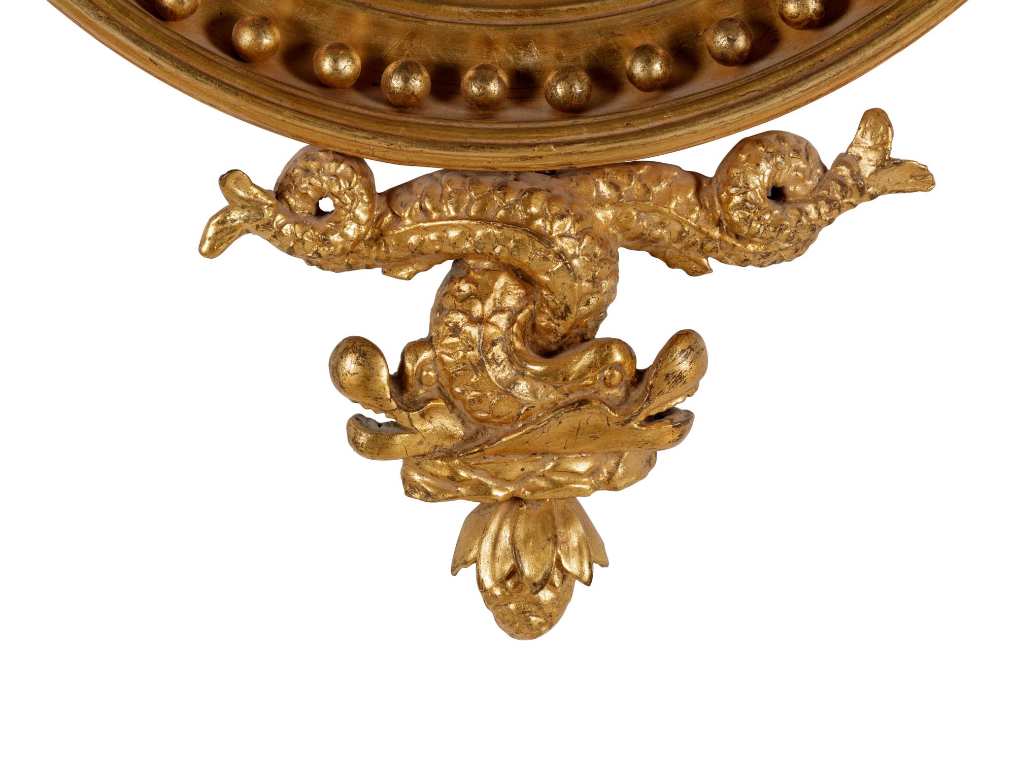 A George III Carved Giltwood Sea Dragon Bull's Eye Mirror