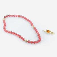 A rhodochrosite and 18K yellow gold bead necklace with citrine and gold brooch