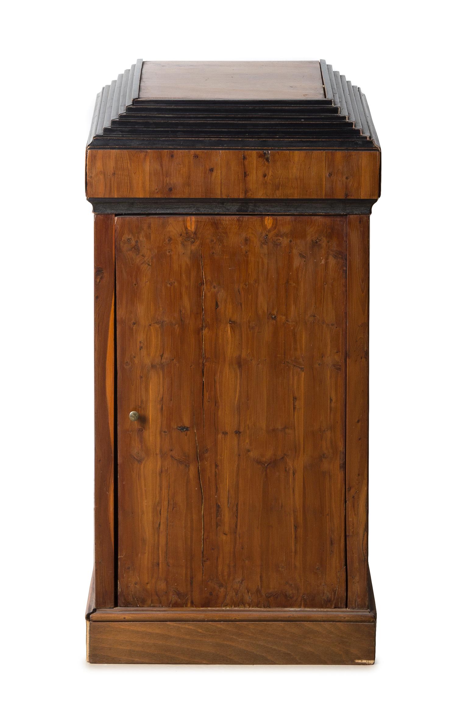 A Biedermeier Parcel Ebonized Fruitwood Side Cabinet Height 31 3/4 x width 15 3/4 x depth 13 3/4 inches. — CIRCA 1825