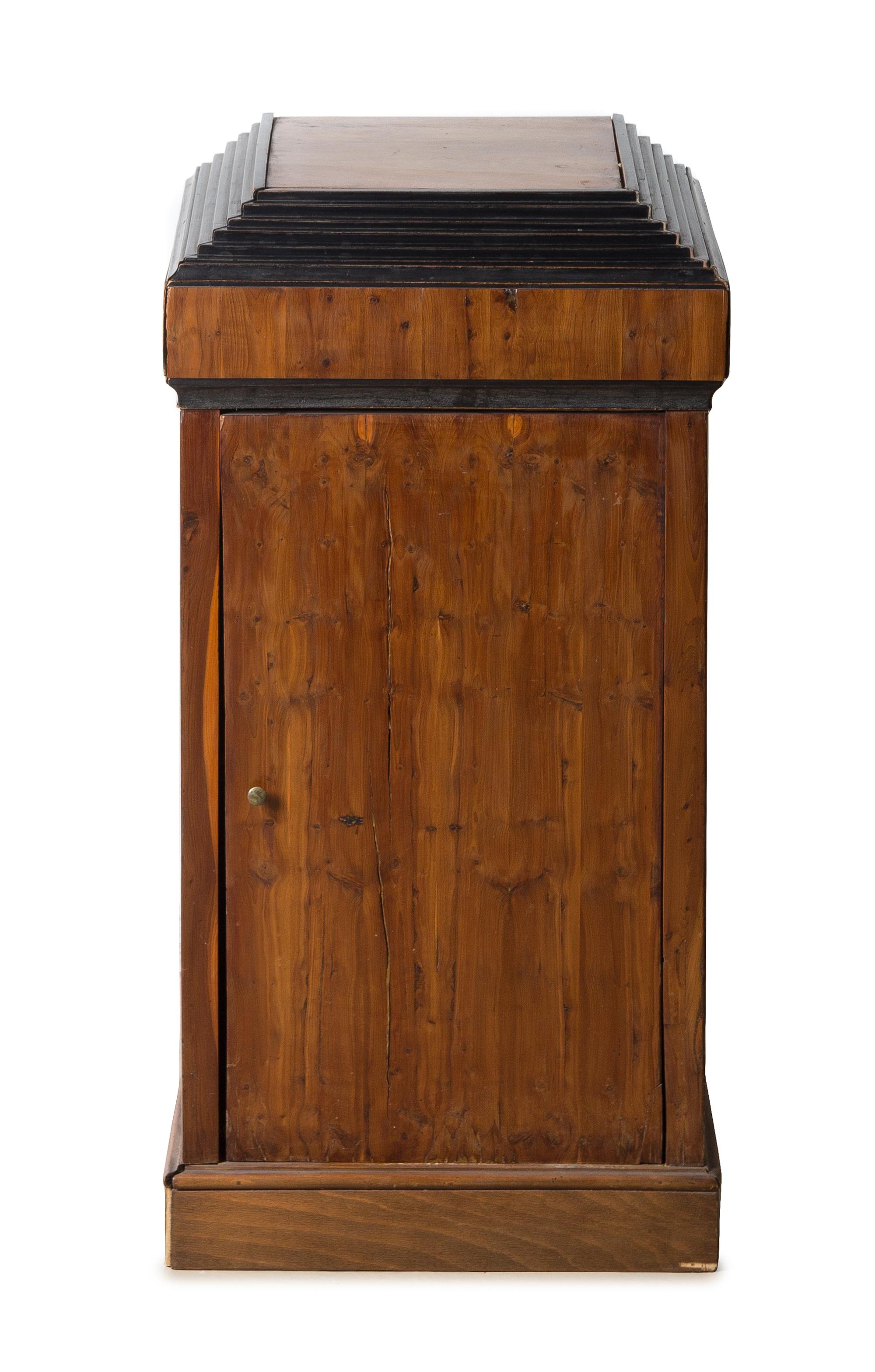 A Biedermeier Parcel Ebonized Fruitwood Side Cabinet Height 31 3/4 x width 15 3/4 x depth 13 3/4 inches. — CIRCA 1825