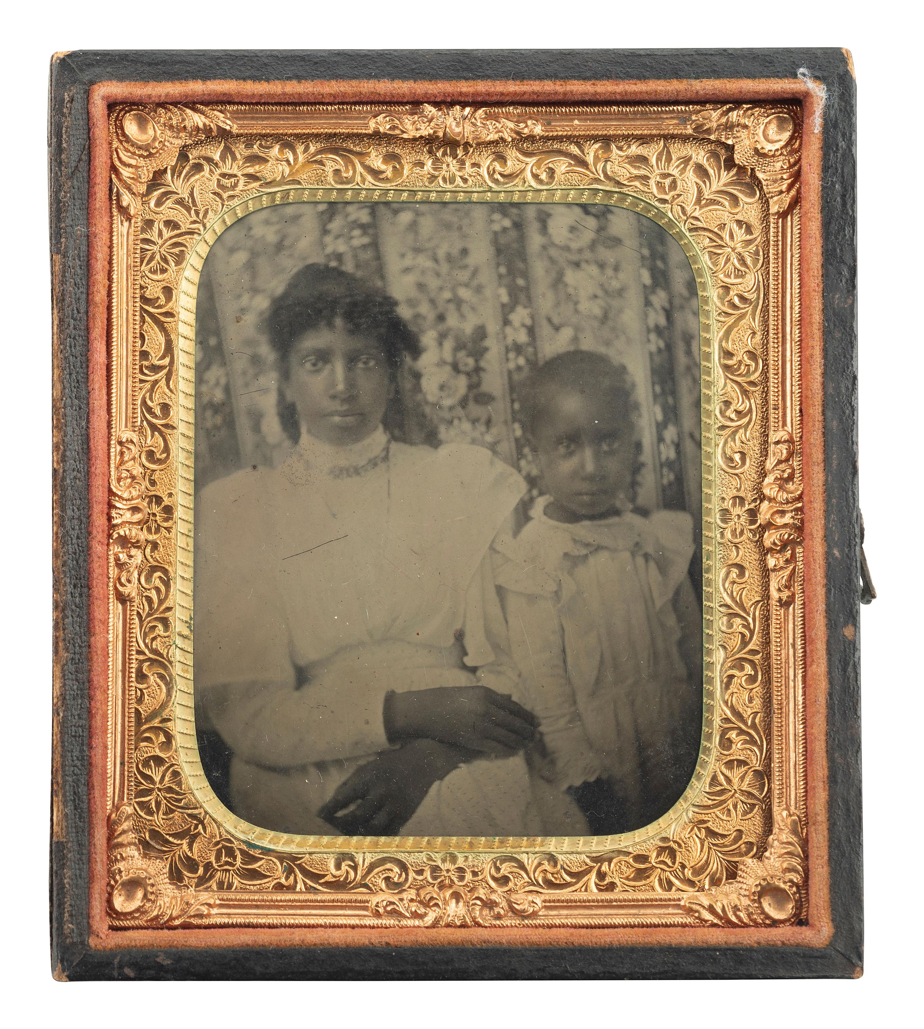 [EARLY PHOTOGRAPHY]. Sixth plate tintype of an African American woman and child.