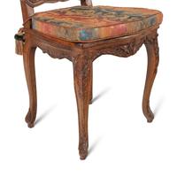 A Set of Eight French Carved Walnut and Caned Dining Chairs