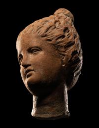 A Greek Terracotta Female Head with Melon Coiffure