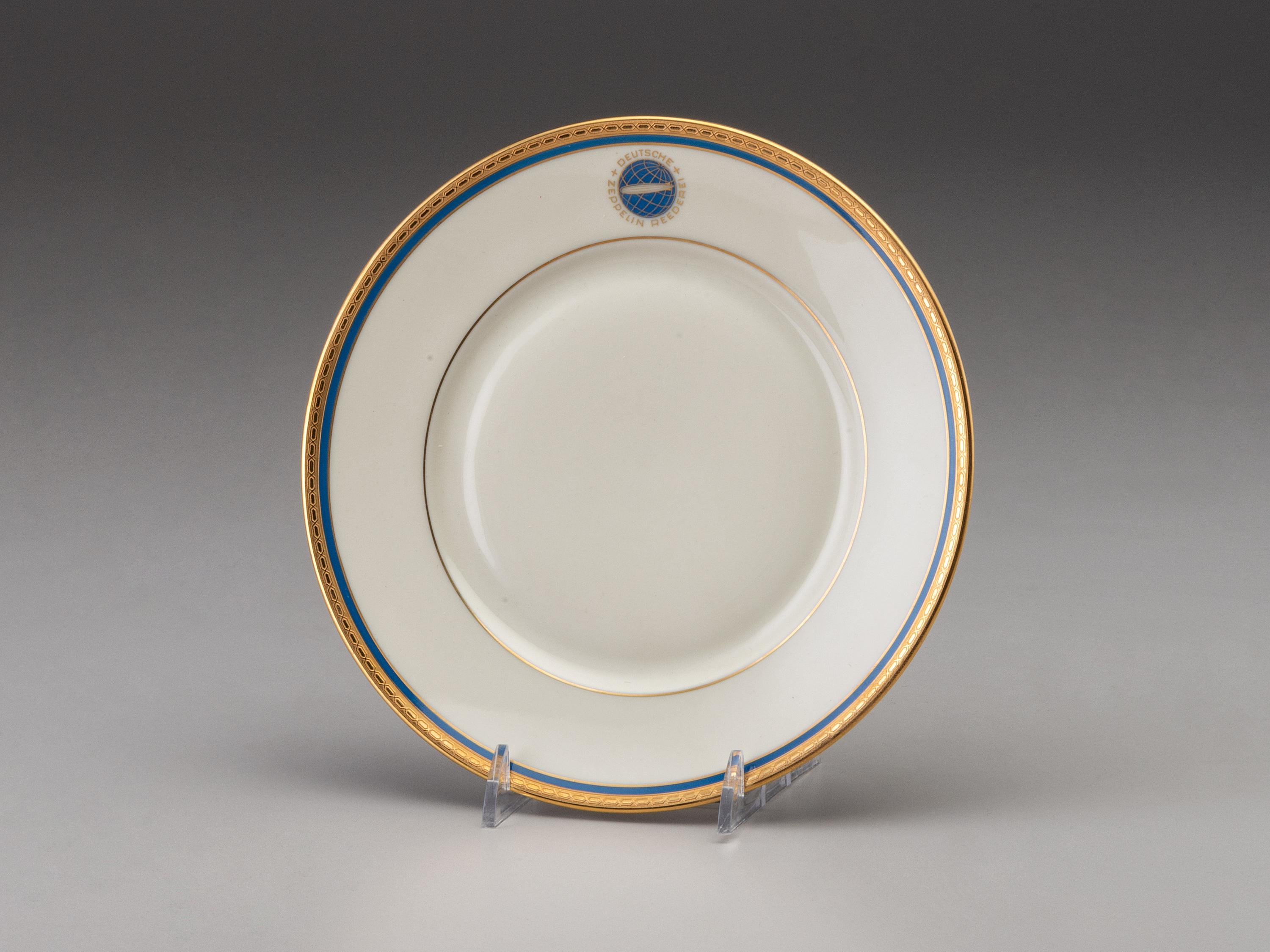 [TRANSPORTATION] - [ZEPPELIN]. Set of Deutsche Zeppelin-Reederei porcelain with dinner plates, salad plates, and sherbet glasses.