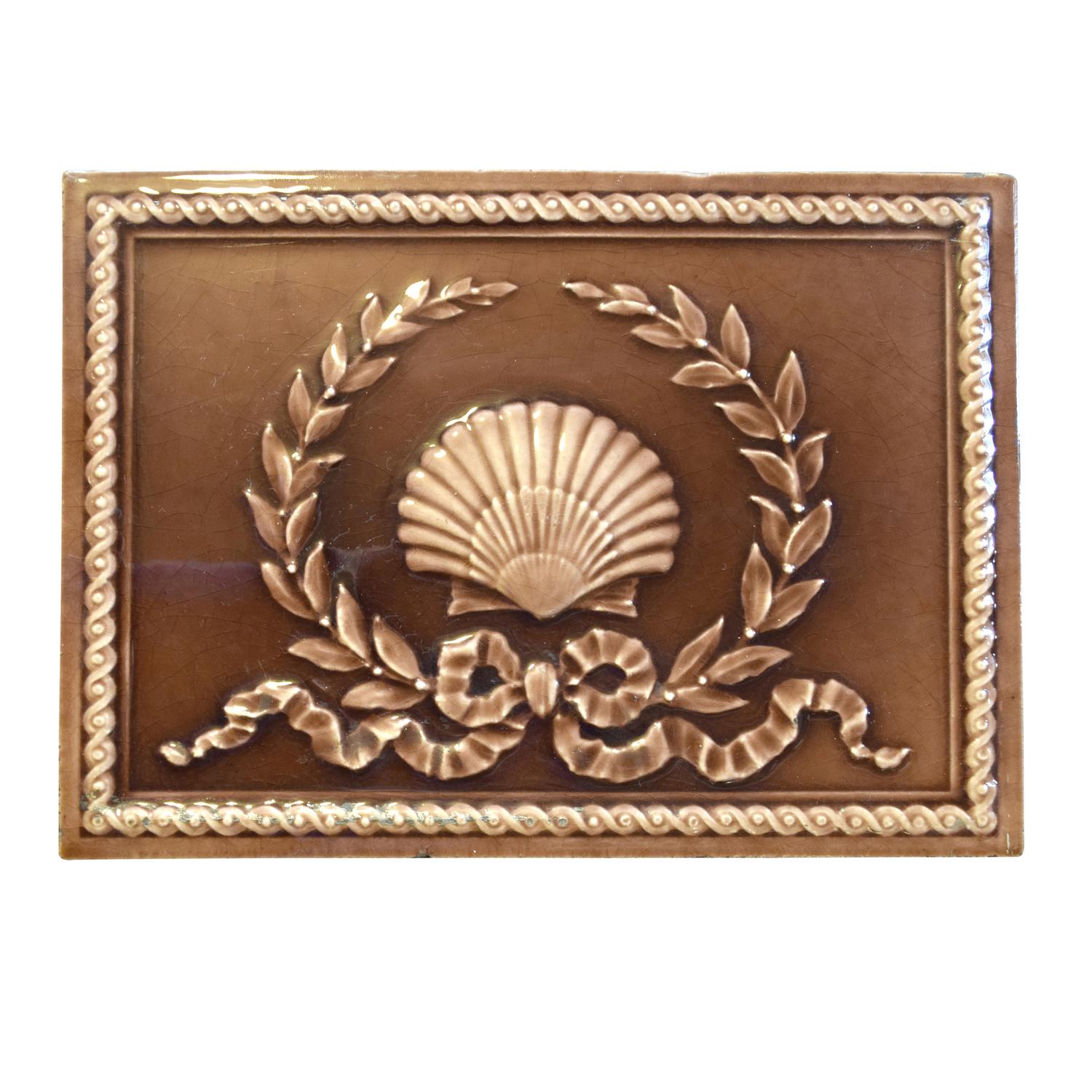 A Shell and Wreath Decorated Glazed Tile 12" W x 1" D x 9" H — United States, Early 20th Century