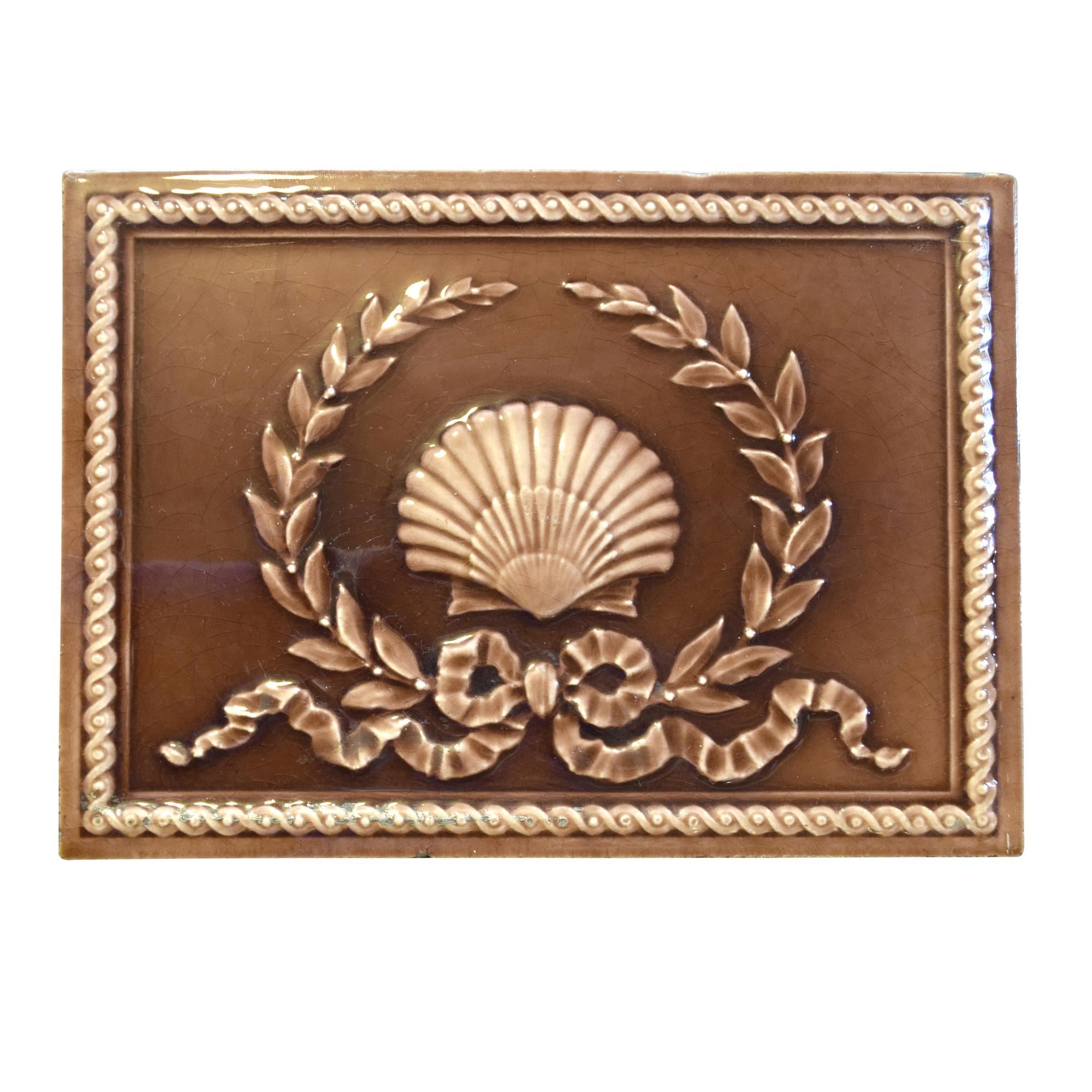 A Shell and Wreath Decorated Glazed Tile 12" W x 1" D x 9" H — United States, Early 20th Century