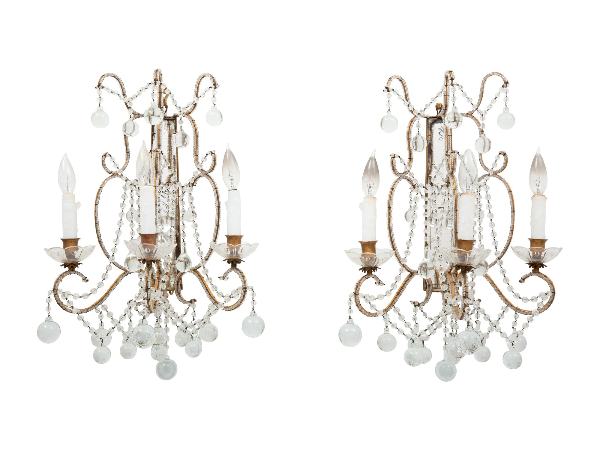A Pair of Neoclassical Style Cut Glass and Mirrored Three-Light Sconces
