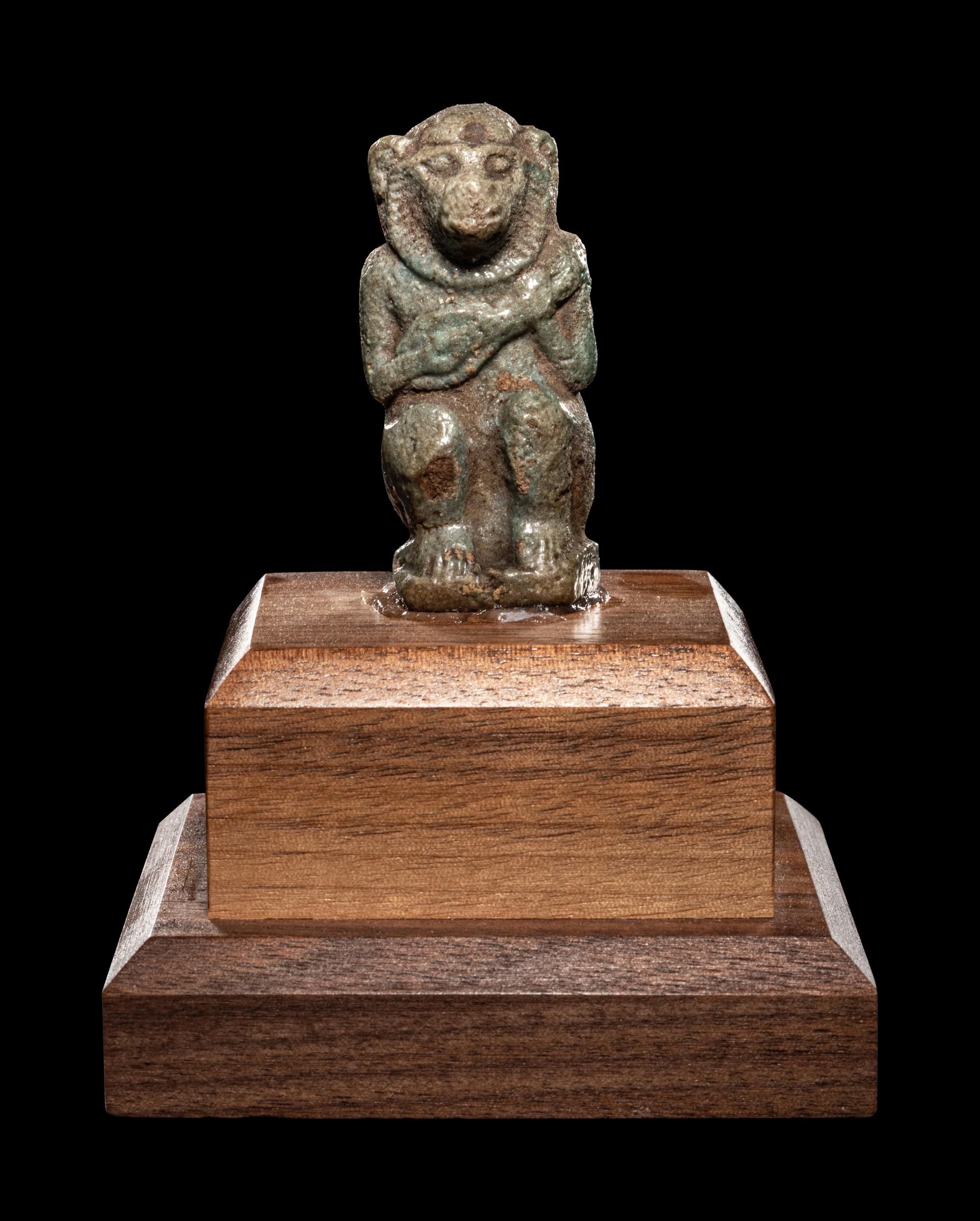 An Egyptian Faience Baboon with Musical Instrument