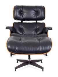 An Eames Laminated Walnut and Black Leather Lounge and Ottoman — FOR HERMAN MILLER