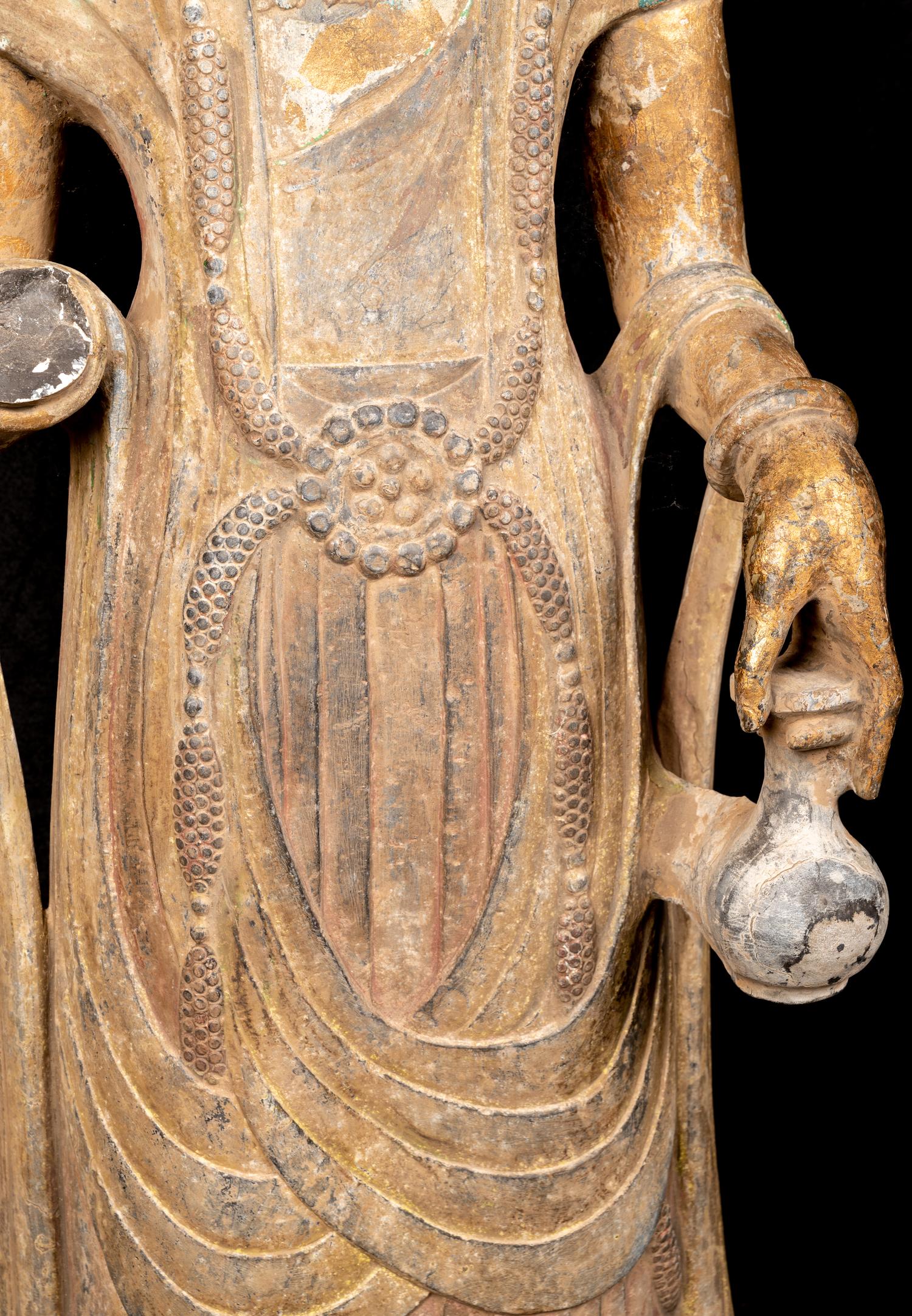 A Chinese Carved Stone Guanyin with Lotus Crown and Remnants of Gilt