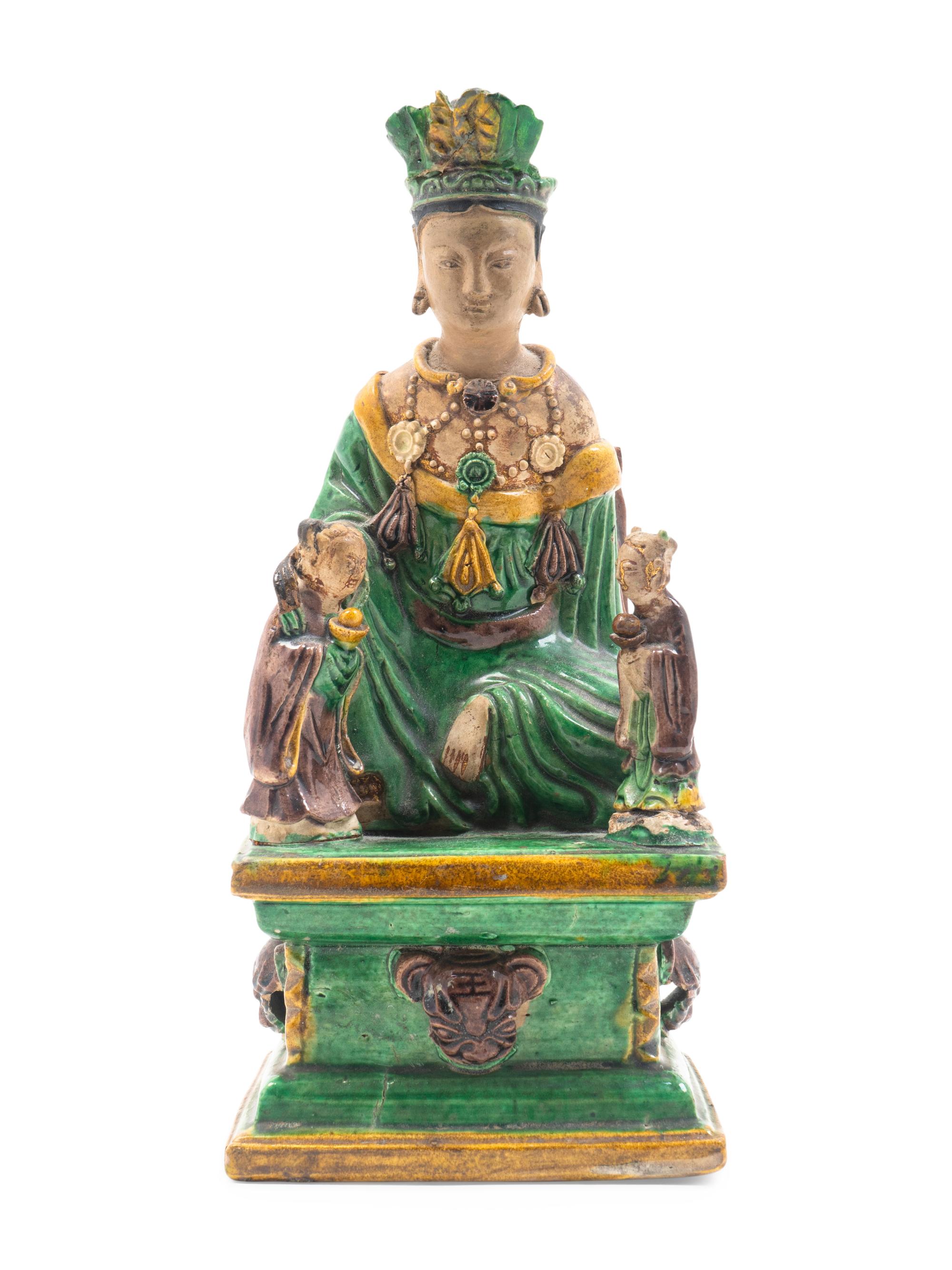 A Chinese Sancai Glazed Stoneware Figure of Seated Guanyin — MING DYNASTY (1368-1644)