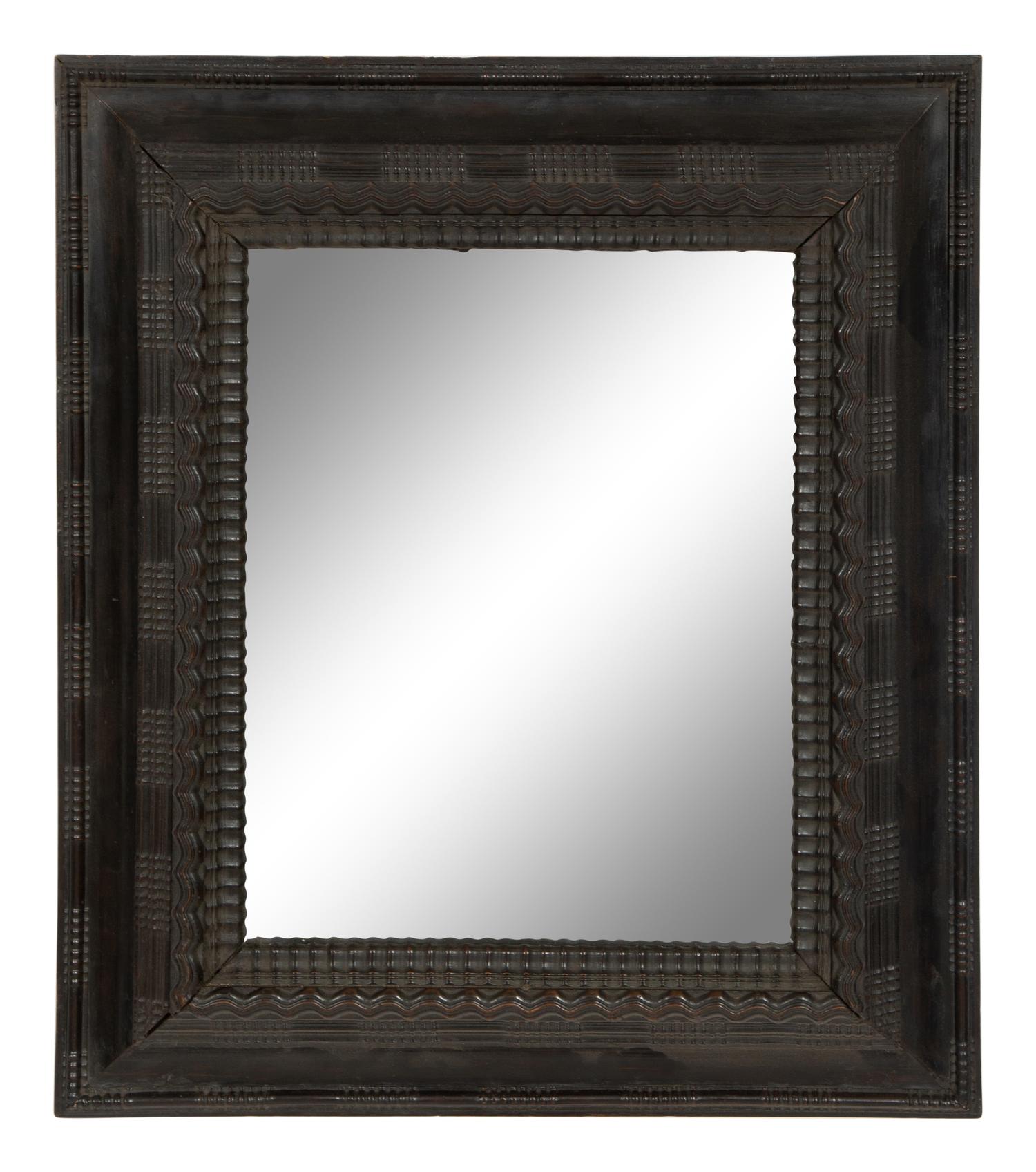 A Continental Ebonized Cushion Mirror