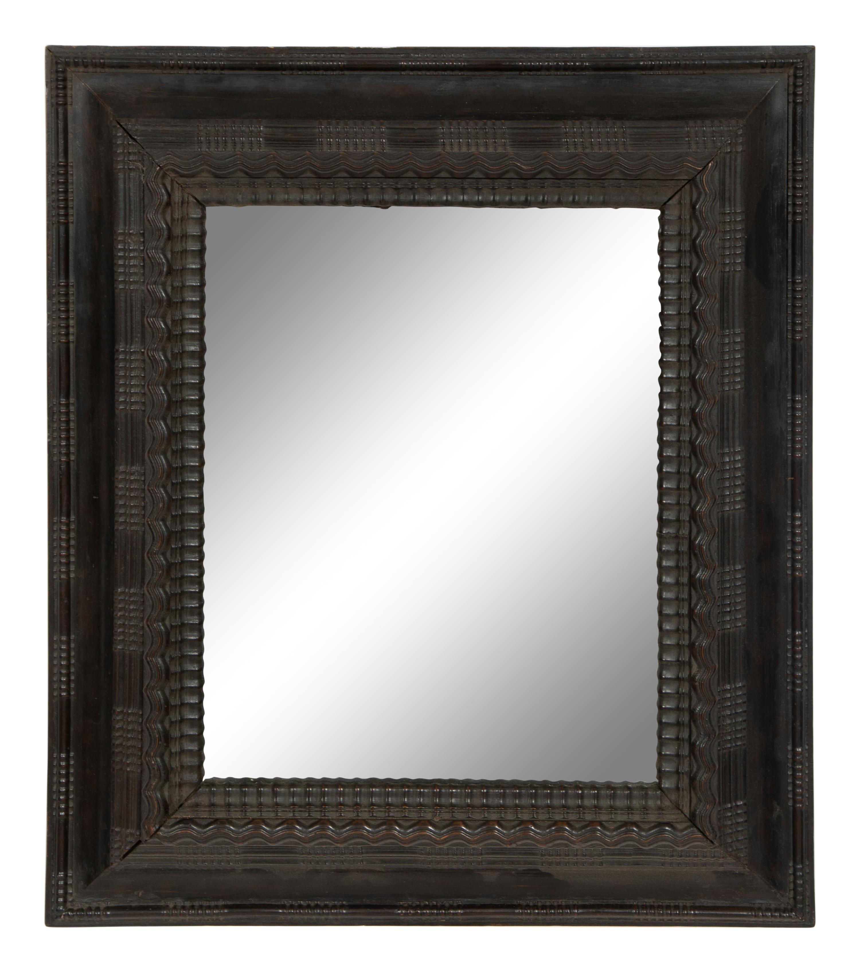 A Continental Ebonized Cushion Mirror