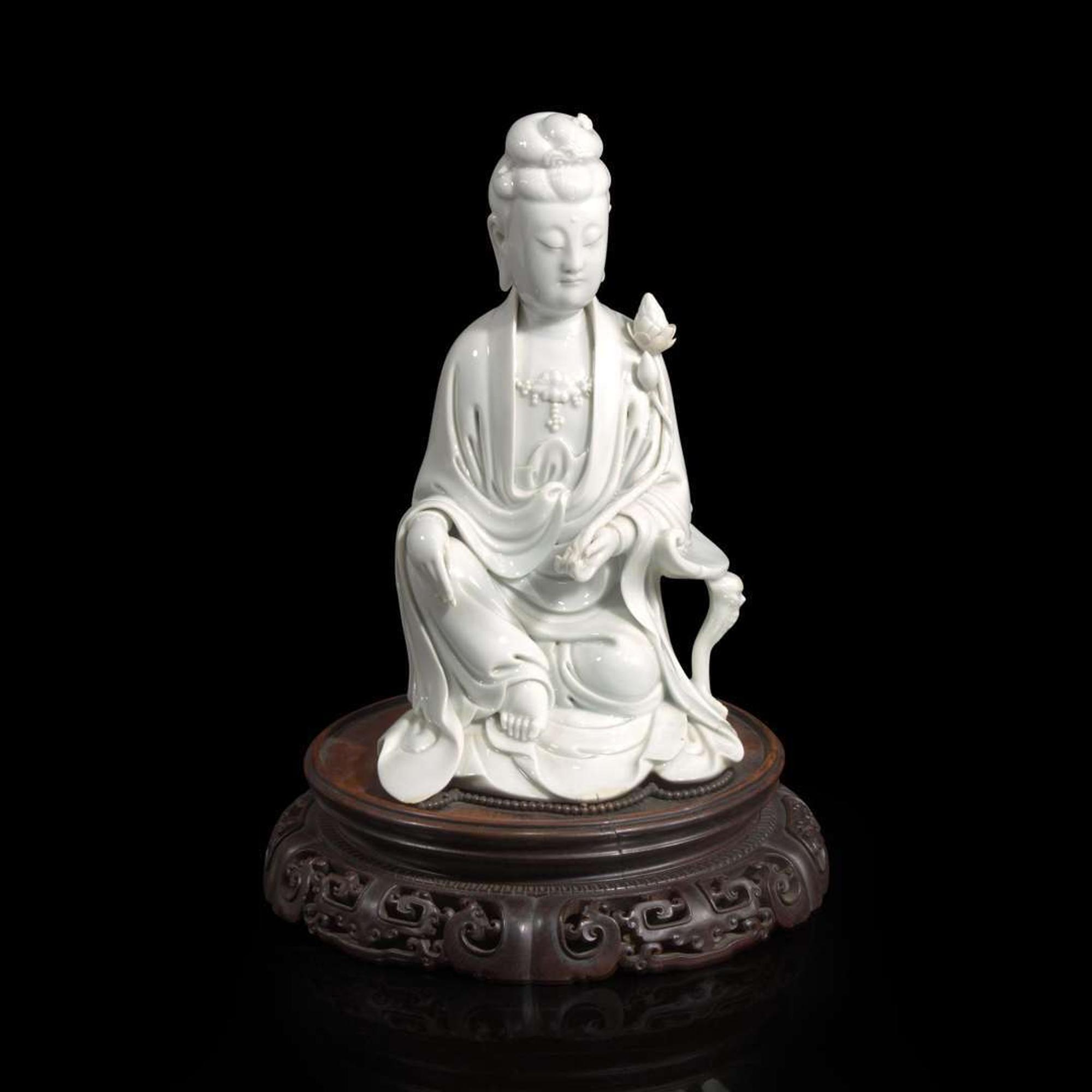 A Chinese blanc de Chine figure of Guanyin seated, with lotus 白瓷持莲观音像 Boji Yuren seal mark ?????