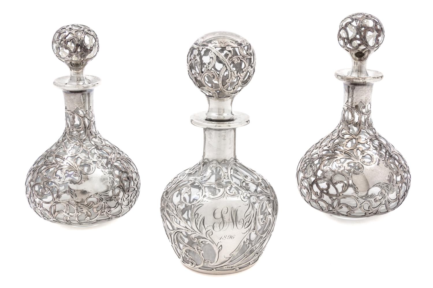 A Group of Three Silver Overlay Glass Bottles Height of tallest 5 1/2 inches.