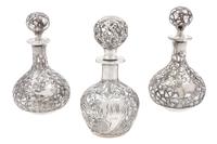A Group of Three Silver Overlay Glass Bottles Height of tallest 5 1/2 inches.