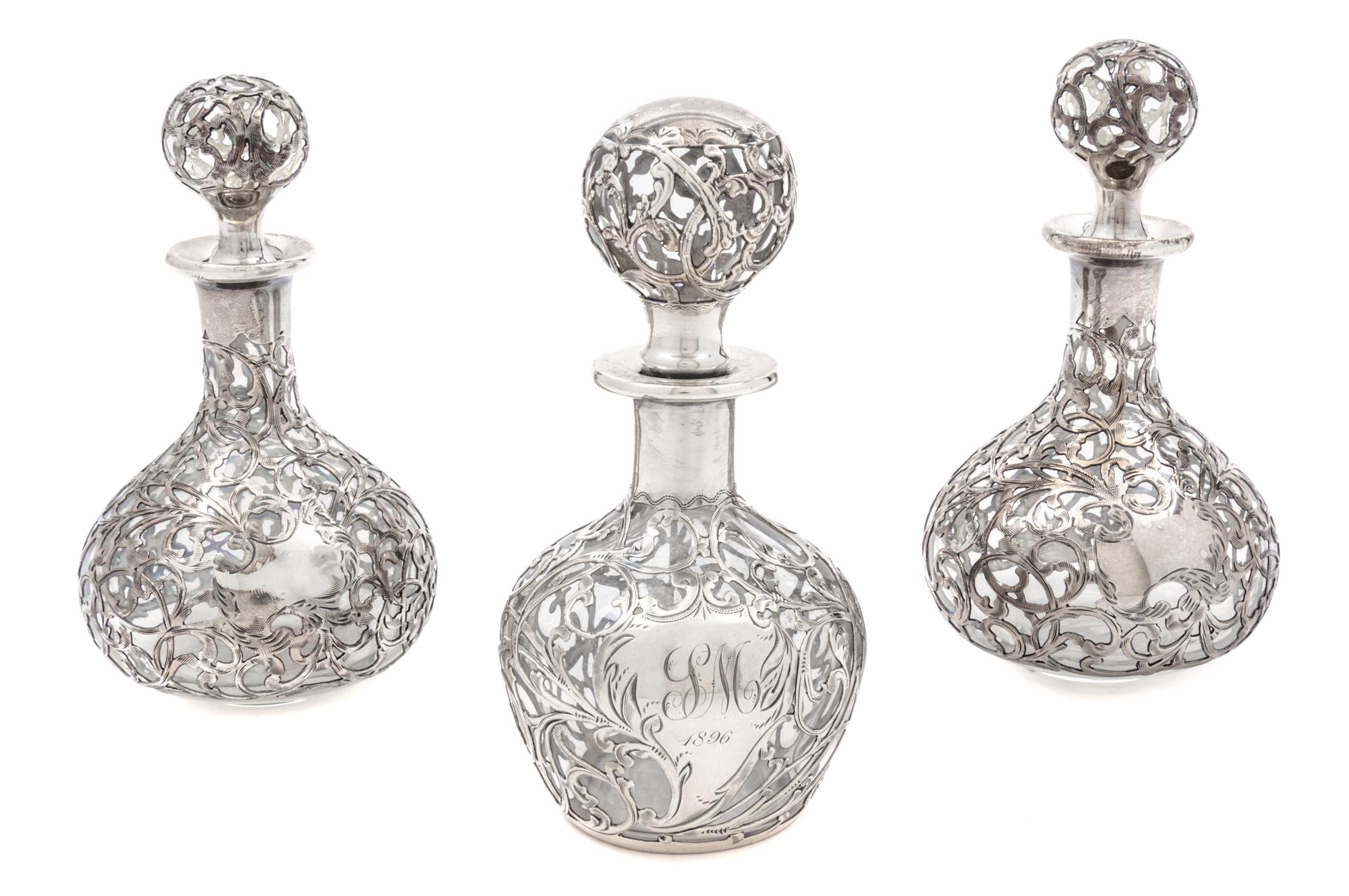 A Group of Three Silver Overlay Glass Bottles Height of tallest 5 1/2 inches.