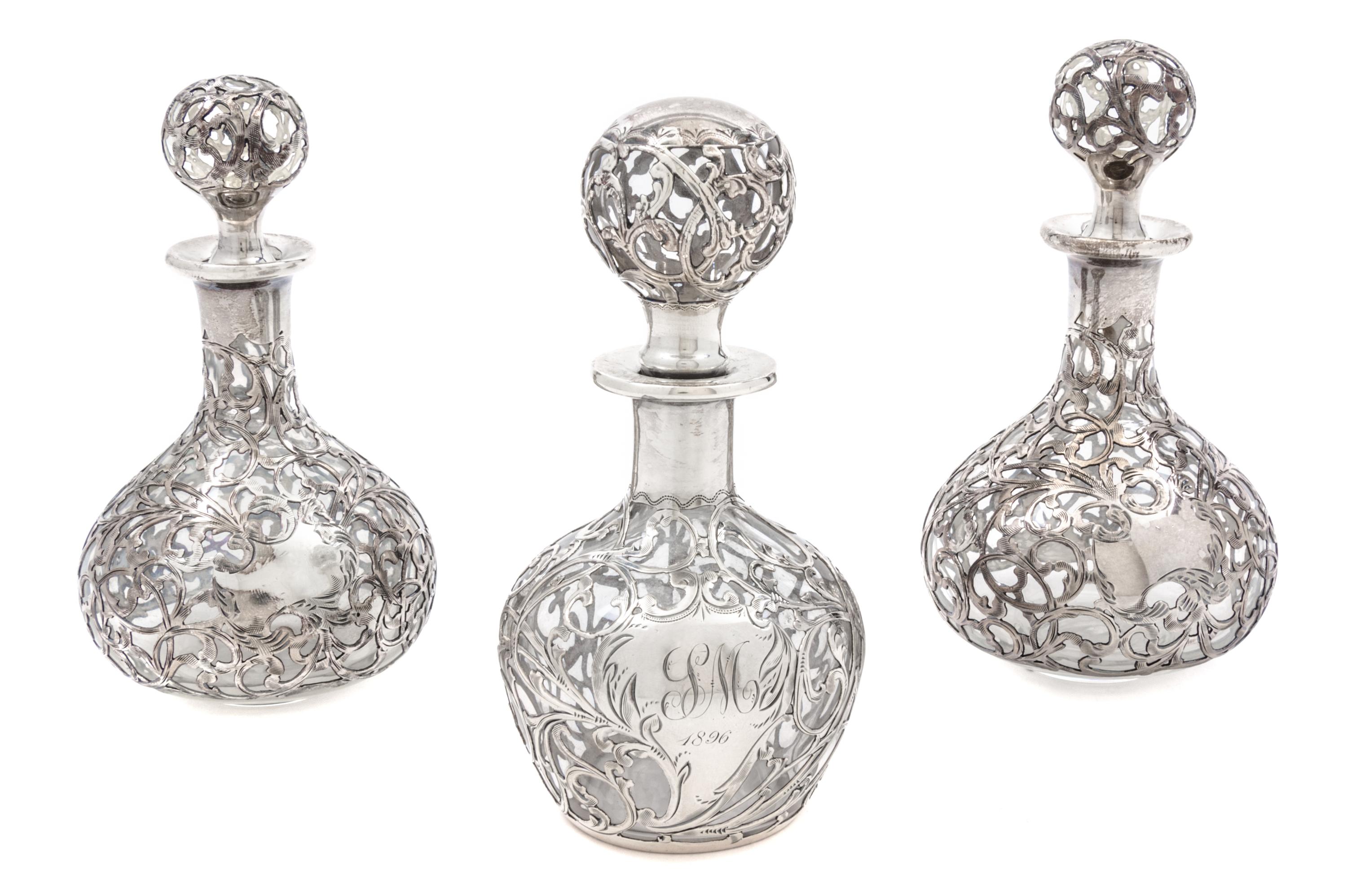 A Group of Three Silver Overlay Glass Bottles Height of tallest 5 1/2 inches.