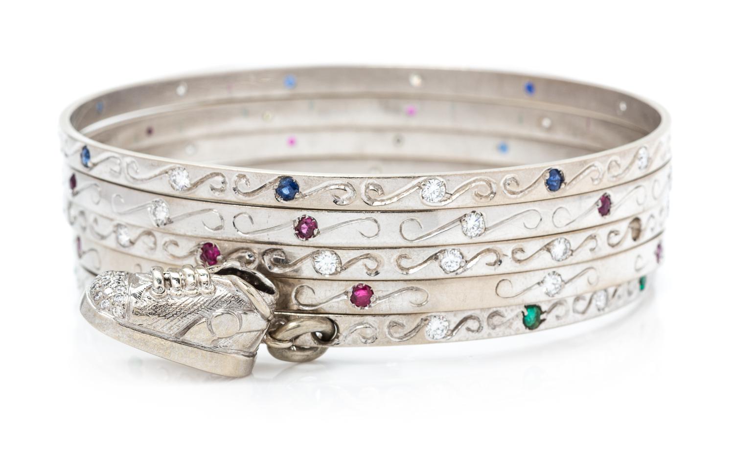 A Collection of 18 Karat White Gold, Diamond, Ruby, Sapphire and Emerald Bangle Bracelets, 69.60 dwts.