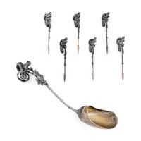 A Tiffany and Co. Silver Nut Scoop and Set of Six Nut Picks