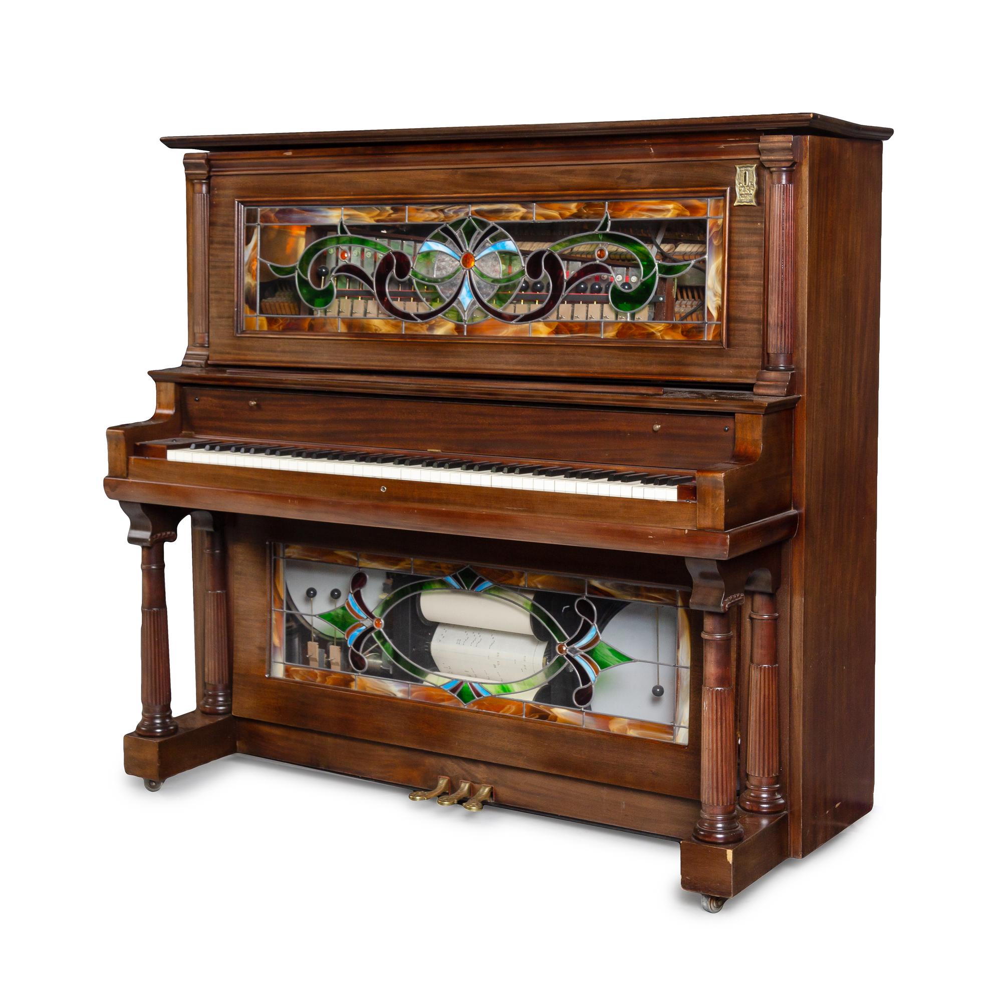 An American Mahogany and Leaded Glass Mounted Orchestrion with an Upholstered Bench