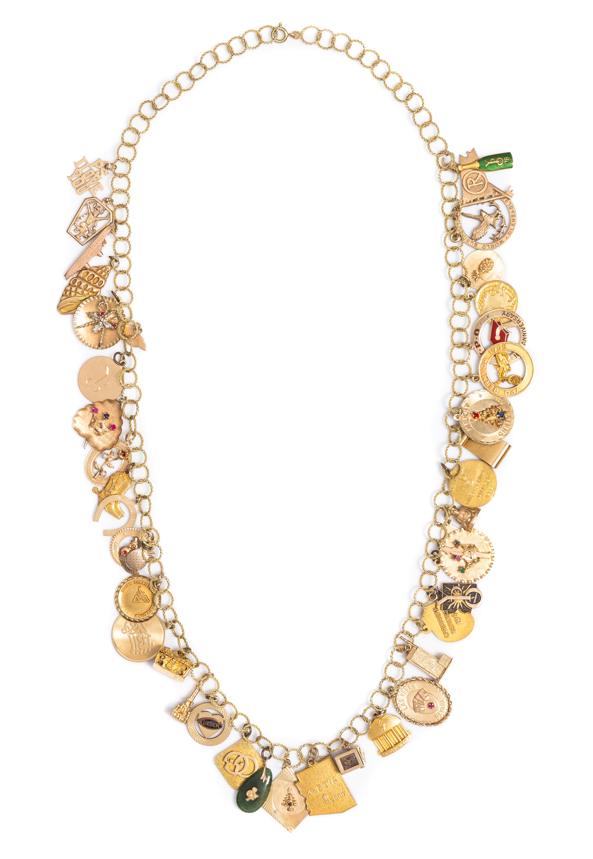 A 14 Karat Yellow Gold Charm Necklace with Numerous Attached Charms, 119.80 dwts.