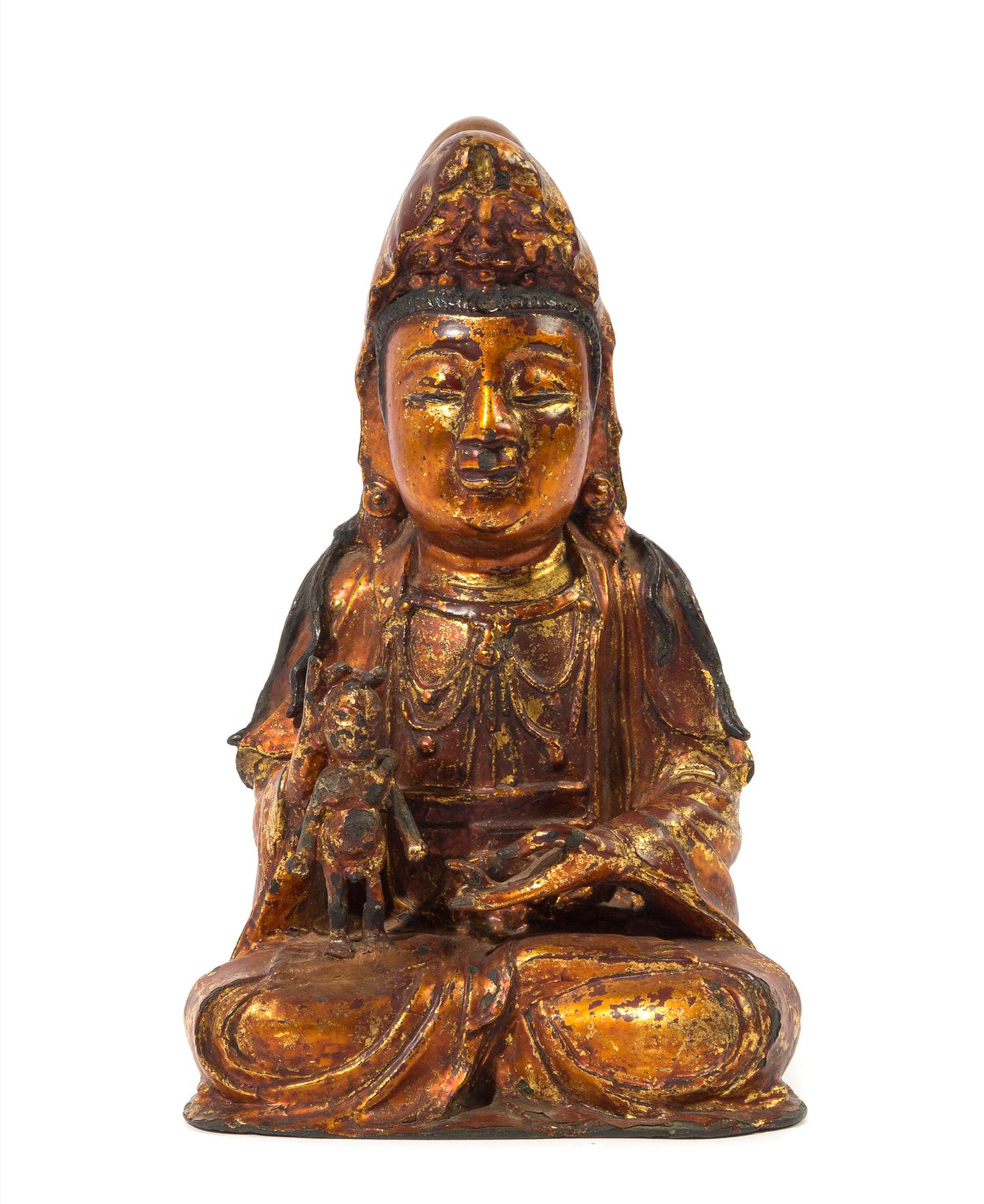A Chinese Gilt and Black Lacquered Bronze Figure of Avalokitesvara MING DYNASTY Height 10 1/2 x width 6 3/4 inches. — MING DYNASTY