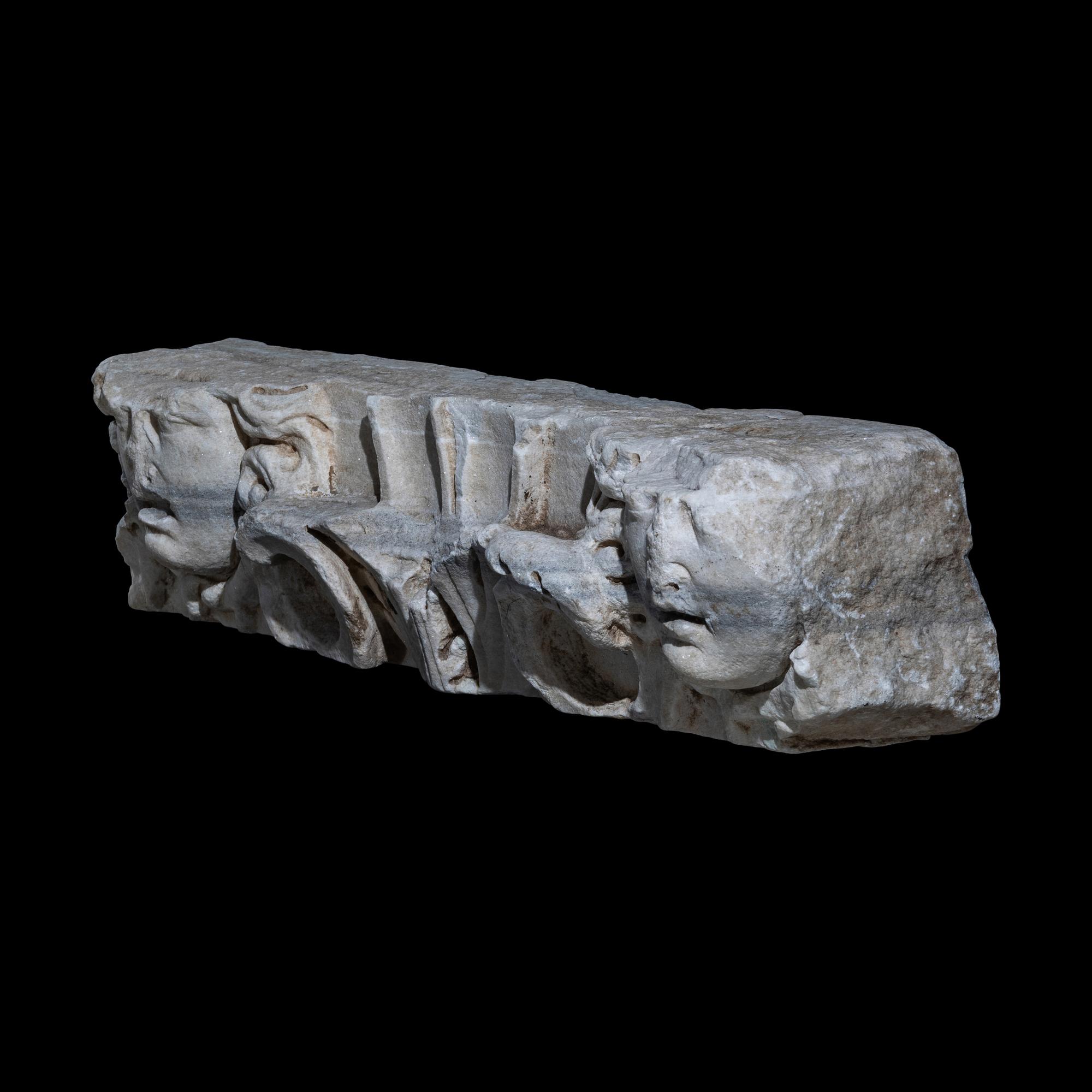 A Roman Marble Frieze Fragment with Heads of Medusa