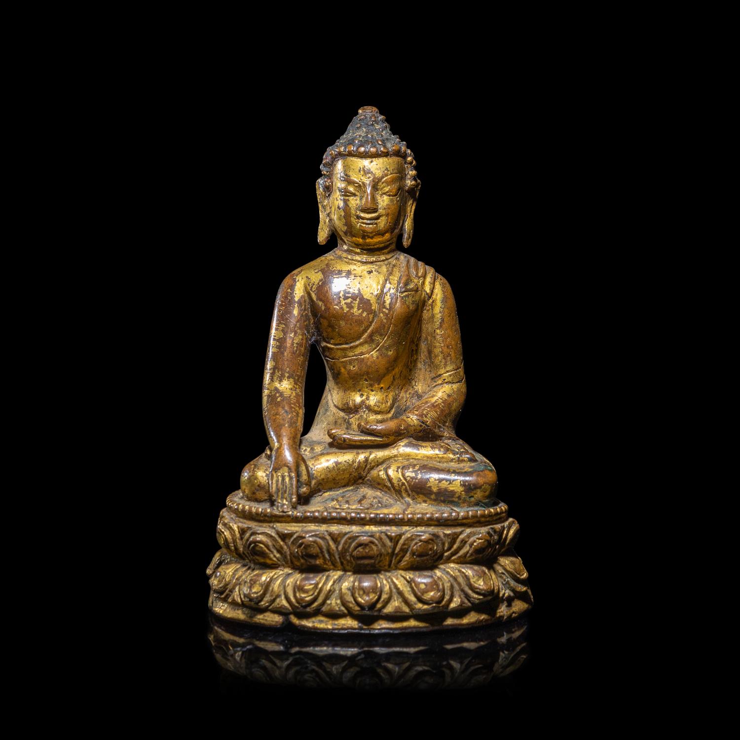 A Tibetan Gilt Copper Alloy Figure of Buddha Shakyamuni, 15th/16th Century 十五/十六世紀 西藏銅鎏金坐佛