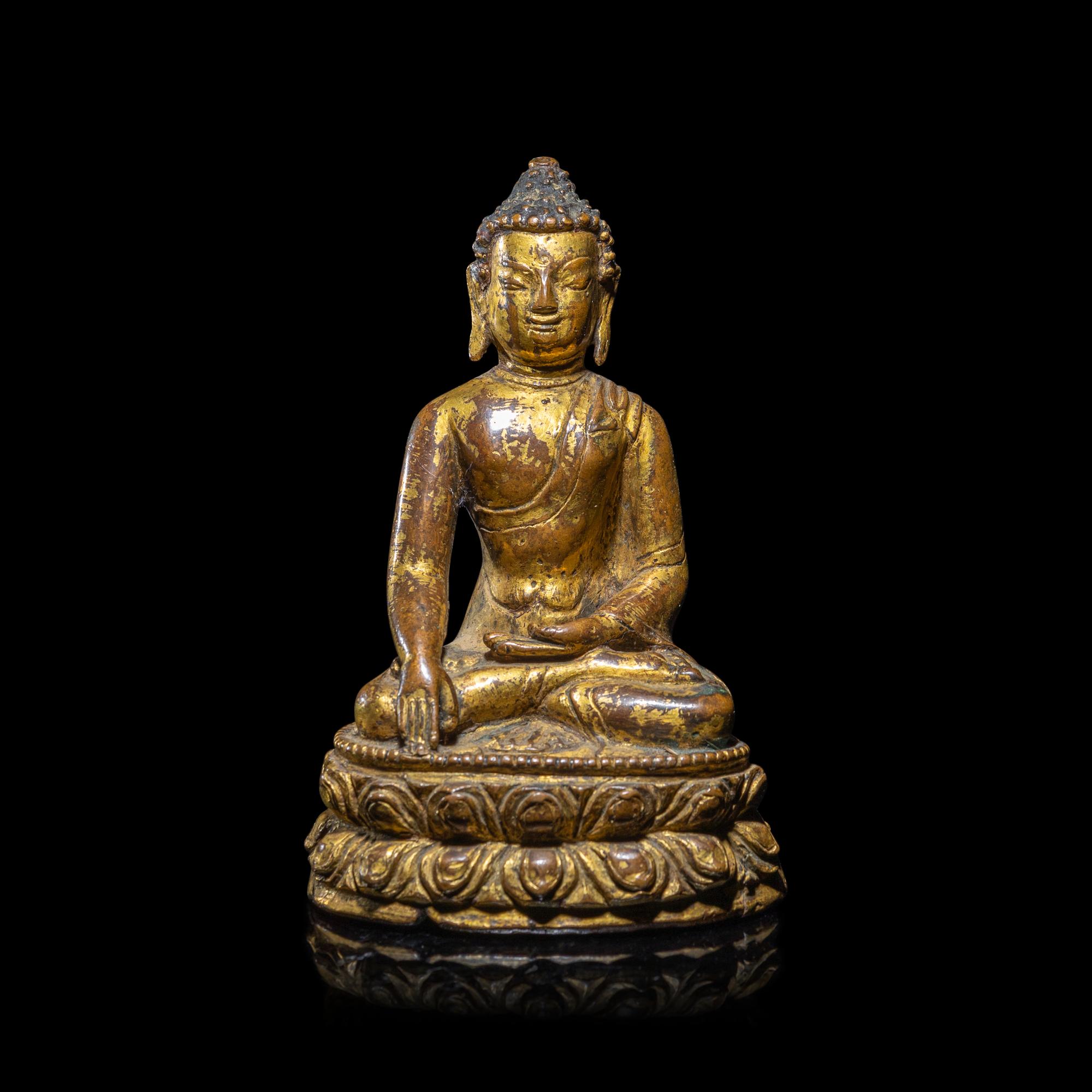 A Tibetan Gilt Copper Alloy Figure of Buddha Shakyamuni, 15th/16th Century 十五/十六世紀 西藏銅鎏金坐佛
