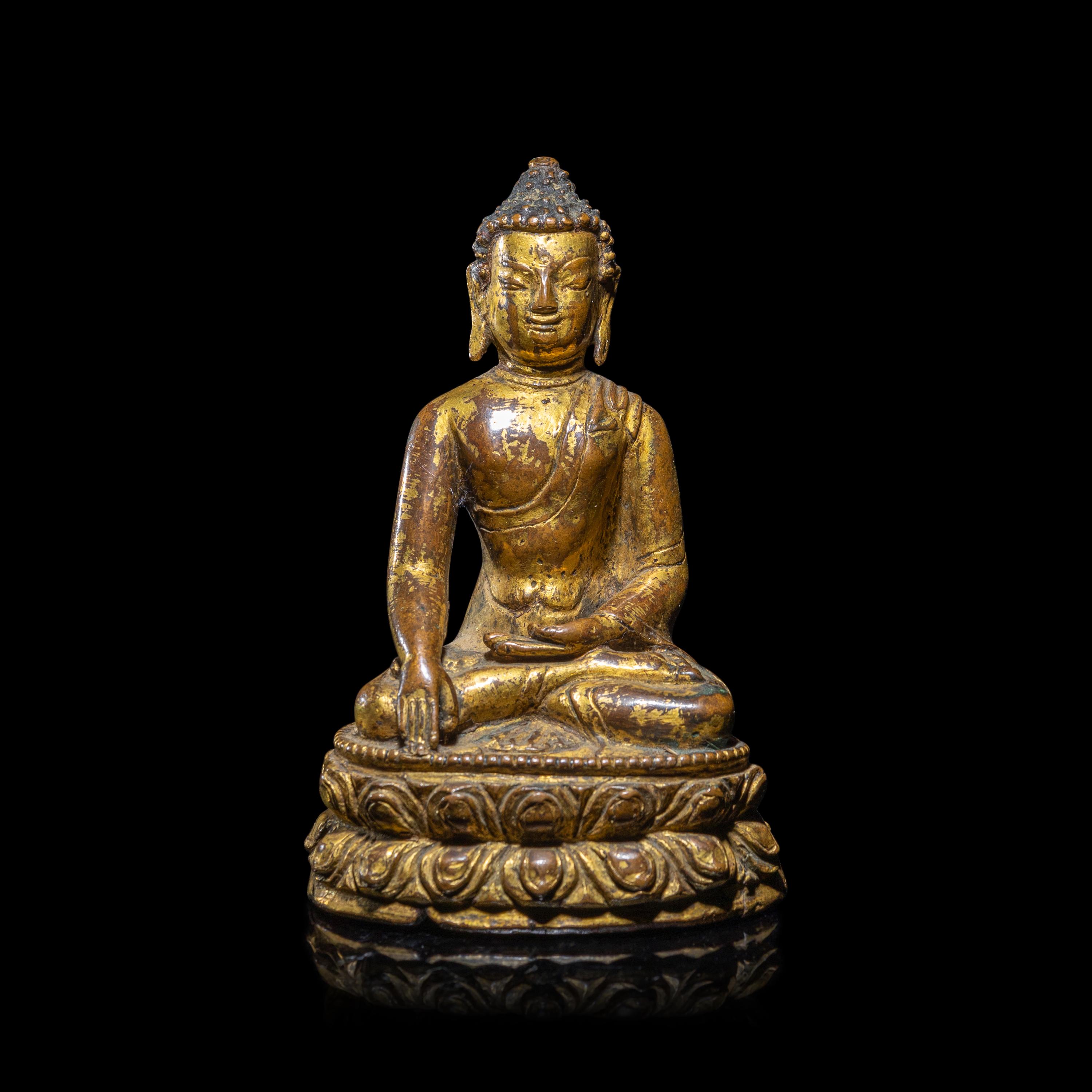 A Tibetan Gilt Copper Alloy Figure of Buddha Shakyamuni, 15th/16th Century 十五/十六世紀 西藏銅鎏金坐佛