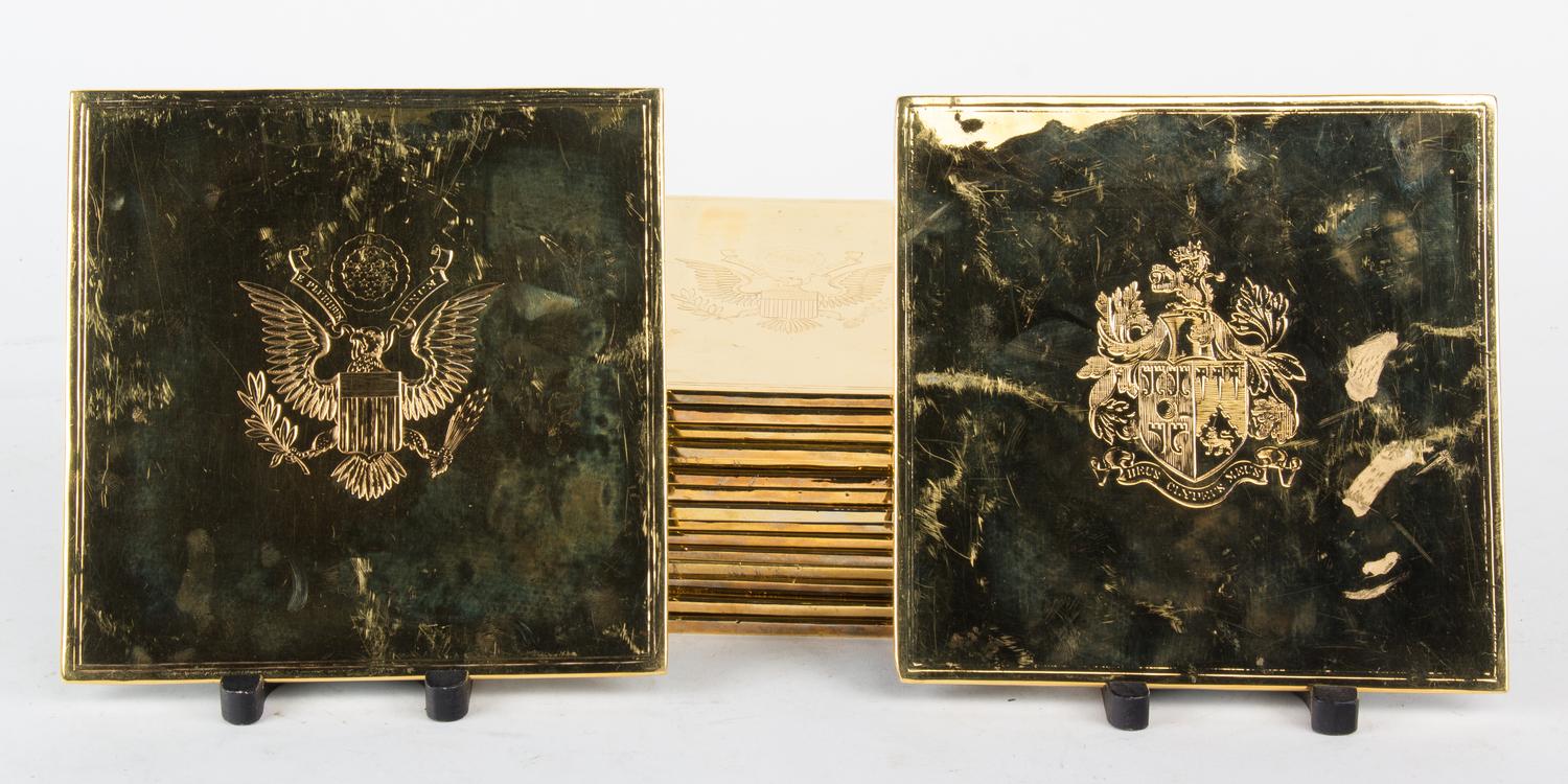 A Set of Seventeen Gold-Plated Trivets Height 7 1/2 x width 7 1/2 inches.
