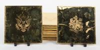 A Set of Seventeen Gold-Plated Trivets Height 7 1/2 x width 7 1/2 inches.